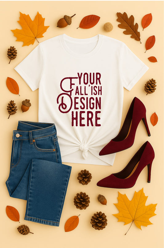 White t-shirt with 'Your Fall Ish Design Here' text, blue jeans, red high heels, and autumn leaves on a beige background