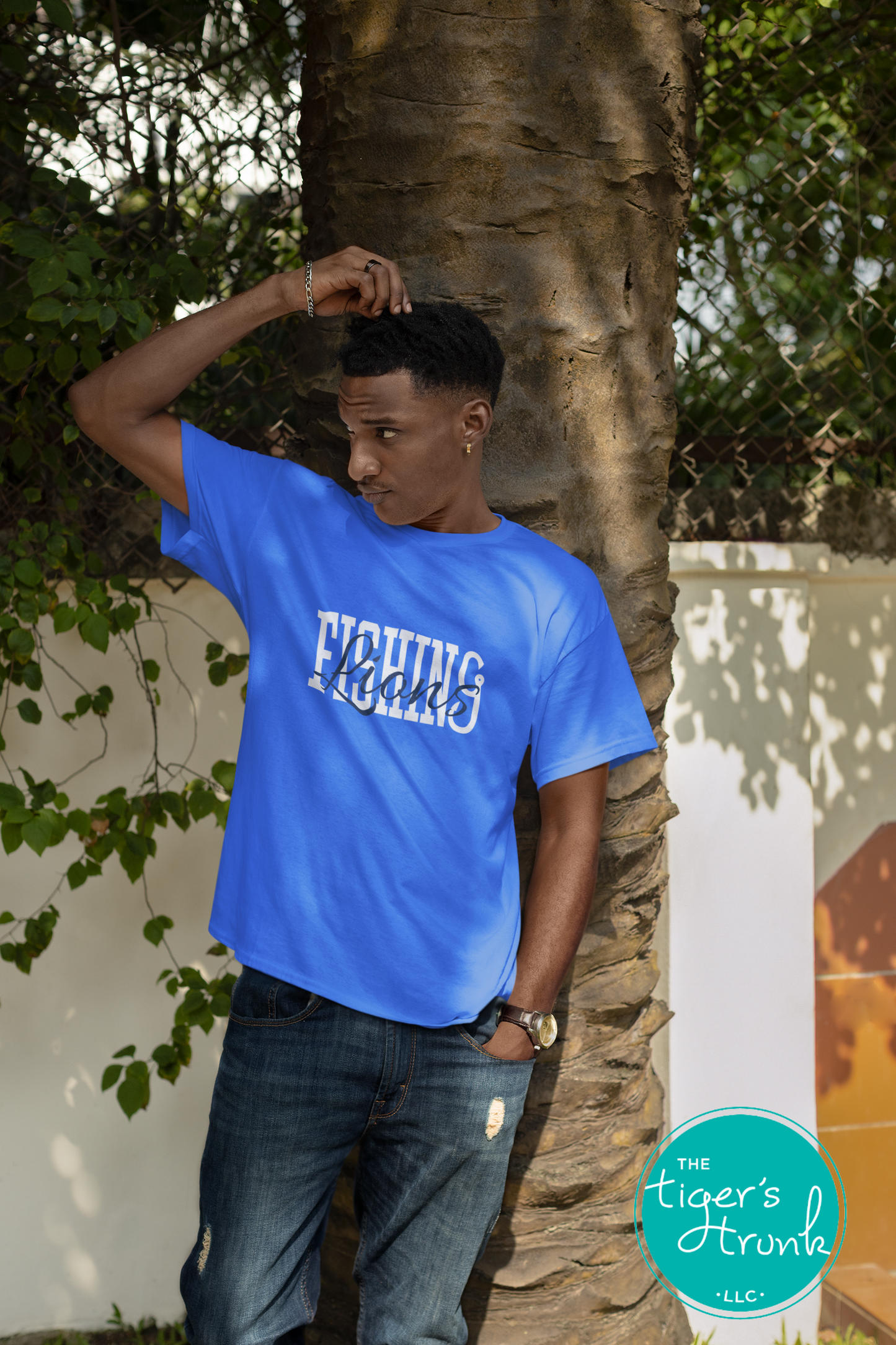 Person wearing a bright blue fishing team shirt with the word Lions in script across the design.