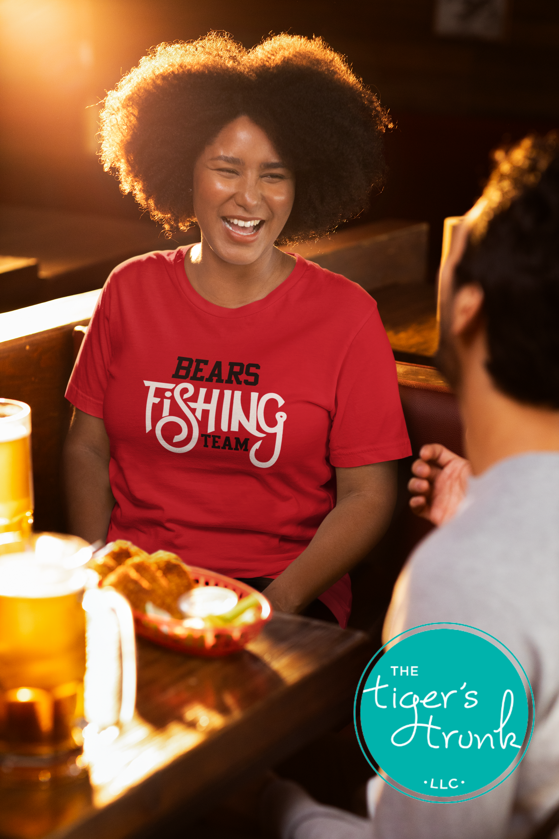 woman laughing in restaurant wearing red personalized Bears fishing team shirt with white design