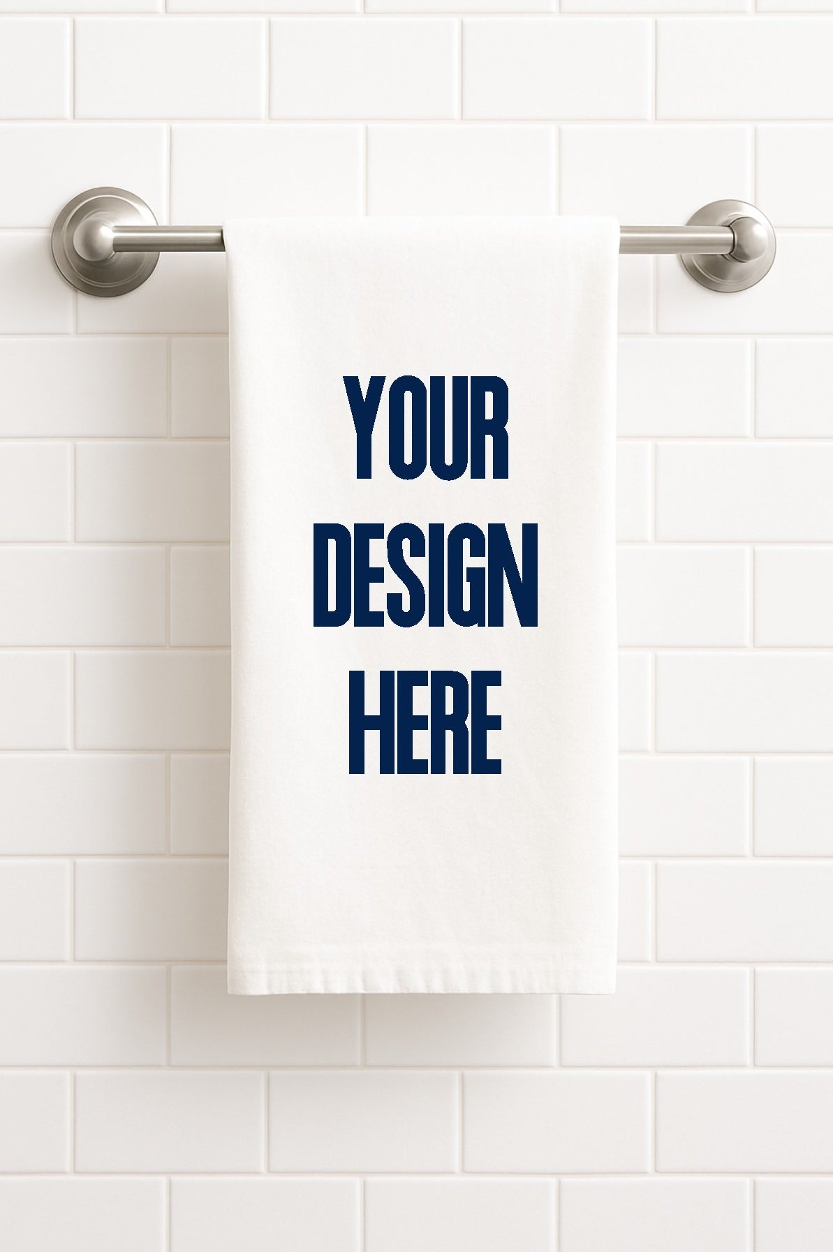 White towel with 'Your Design Here' text on a white tiled wall