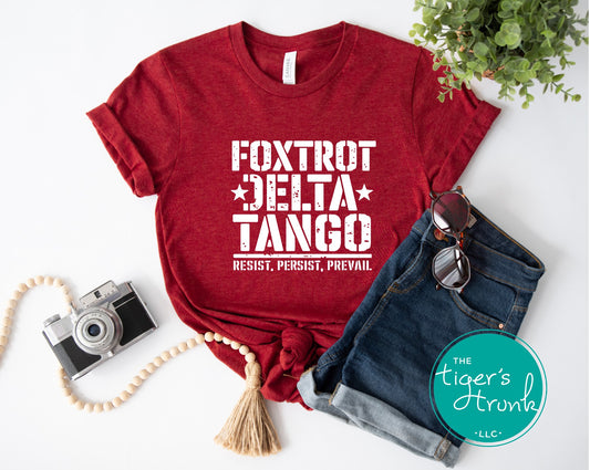 Red t-shirt with 'Foxtrot Delta Tango' text, denim shorts, camera, and sunglasses on a white background.