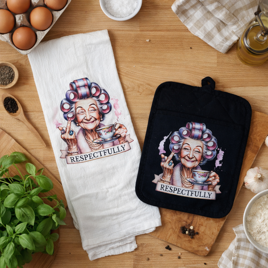Kitchen towel and pot holder with cartoon character and 'RESPECTFULLY' text on a wooden surface.