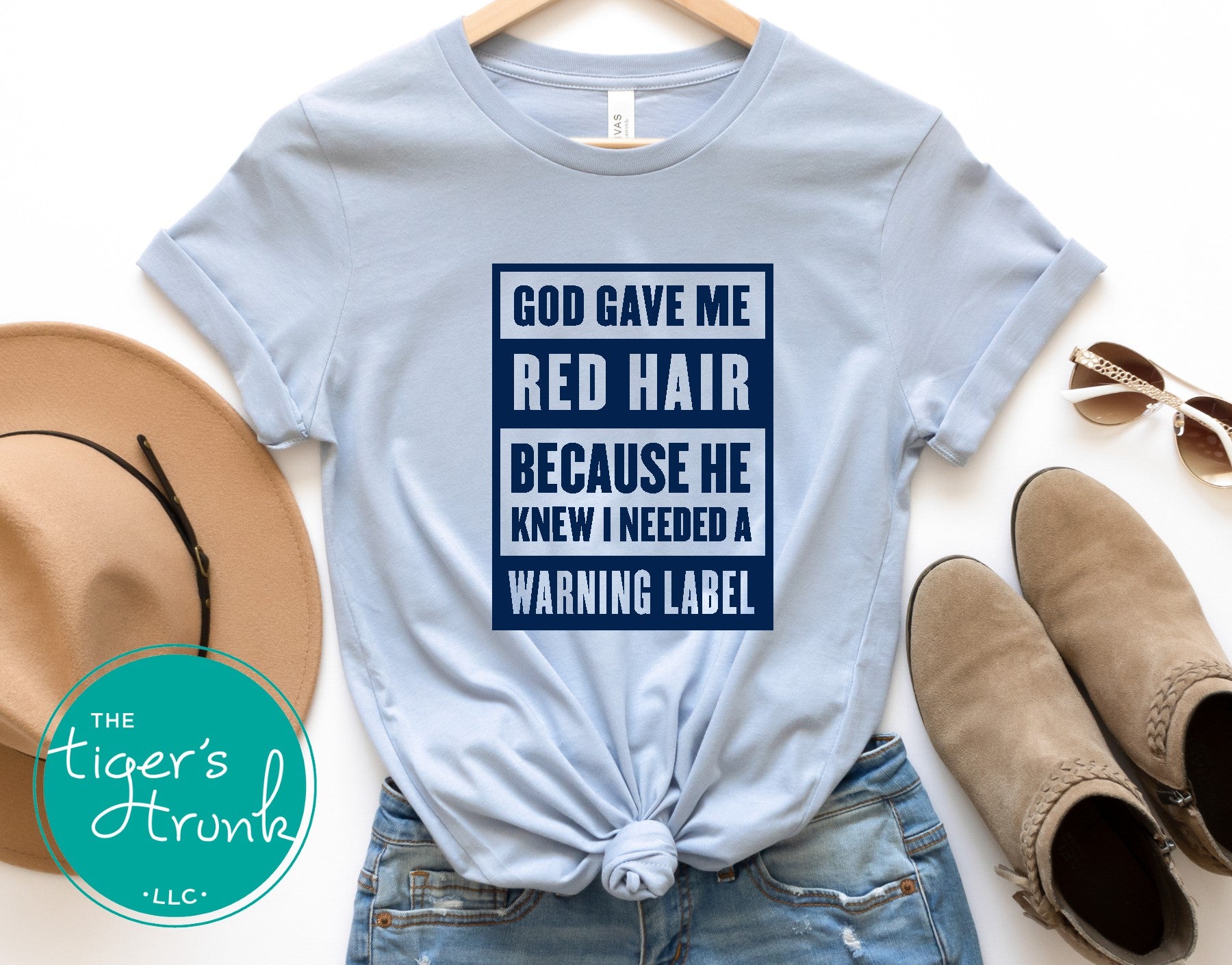 light blue graphic tee with god gave me red hair warning label design