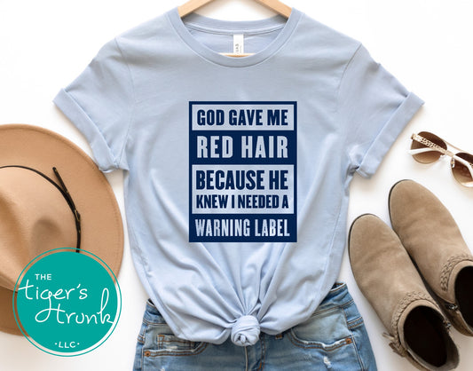 light blue graphic tee with god gave me red hair warning label design