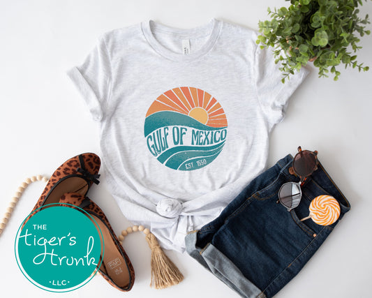 Coastal sunset and wave t-shirt with Gulf of Mexico, Est. 1550—a historical protest statement against renaming the Gulf