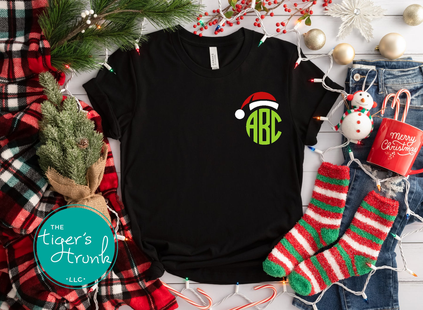 Black t-shirt with Christmas-themed design on a festive background with stockings and decorations.