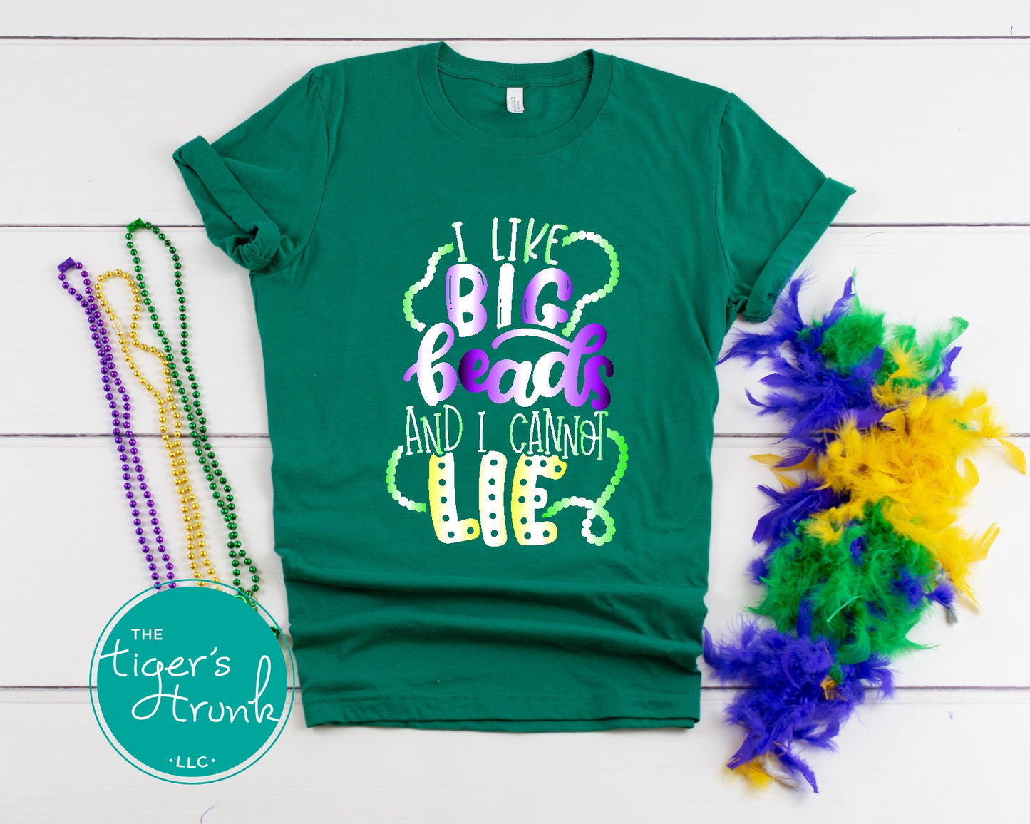 Funny Mardi Gras shirt reading "I Like Big Beads and I Cannot Lie" with a watercolor ombre design in purple, green, and gold.