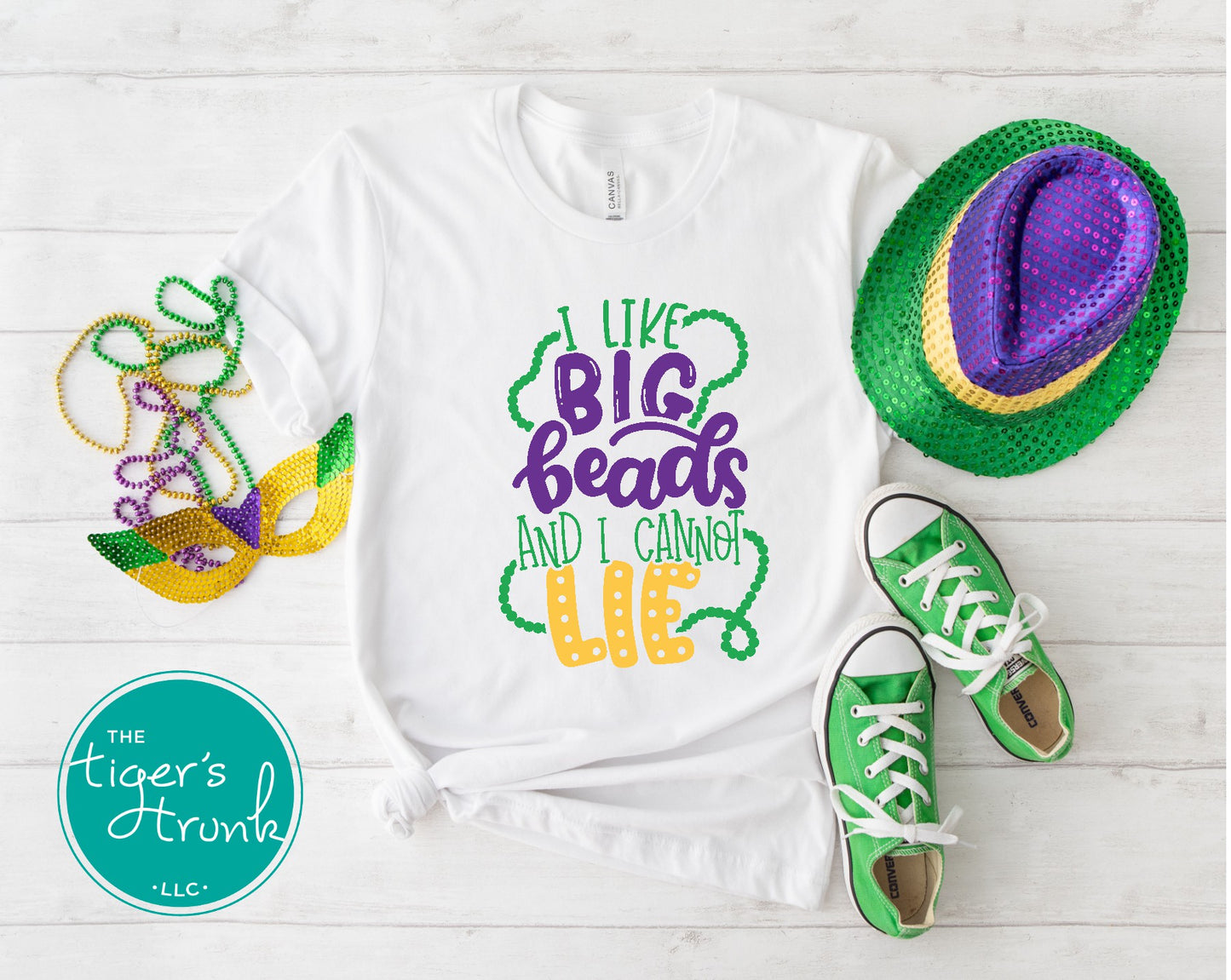 Funny Mardi Gras shirt reading "I Like Big Beads and I Cannot Lie" with a watercolor ombre design in purple, green, and gold.