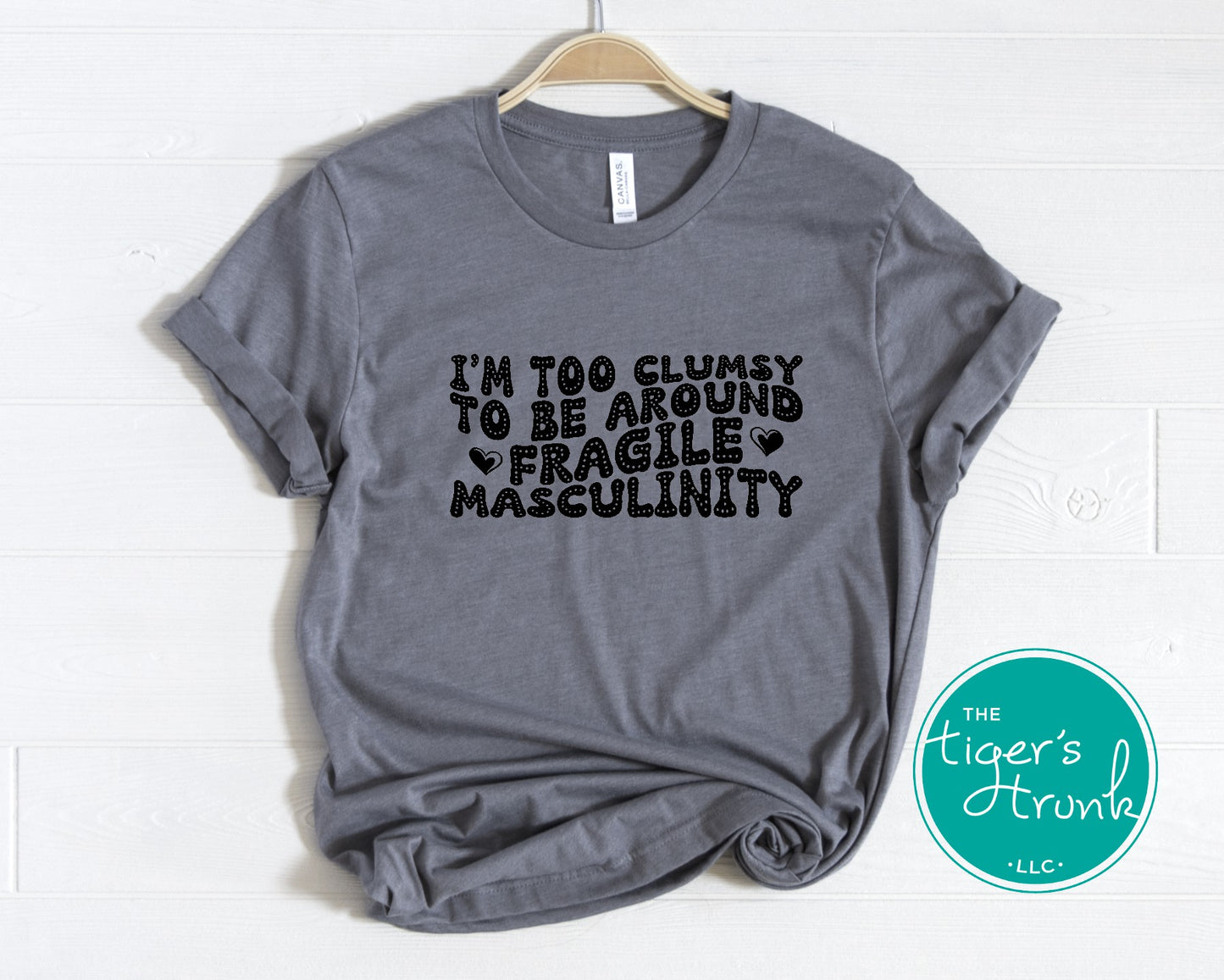 Funny feminist t-shirt with I’m Too Clumsy to Be Around Fragile Masculinity message, bold social commentary apparel