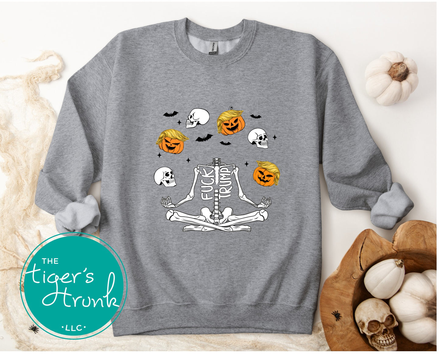 Gray sweatshirt with Halloween-themed design featuring pumpkins, skulls, and a skeleton on a white background.