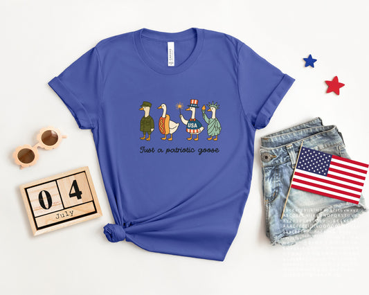 Funny patriotic t-shirt with four geese dressed as a soldier, hotdog, statue, and red-white-blue icon, reading Just a Patriotic Goose
