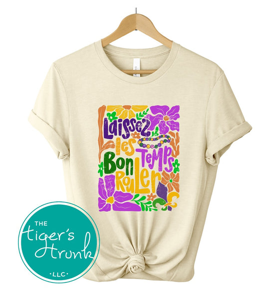 Tropical vintage-style Mardi Gras t-shirt with the phrase "Laissez les Bon Temps Rouler" in classic purple, green, and gold colors.