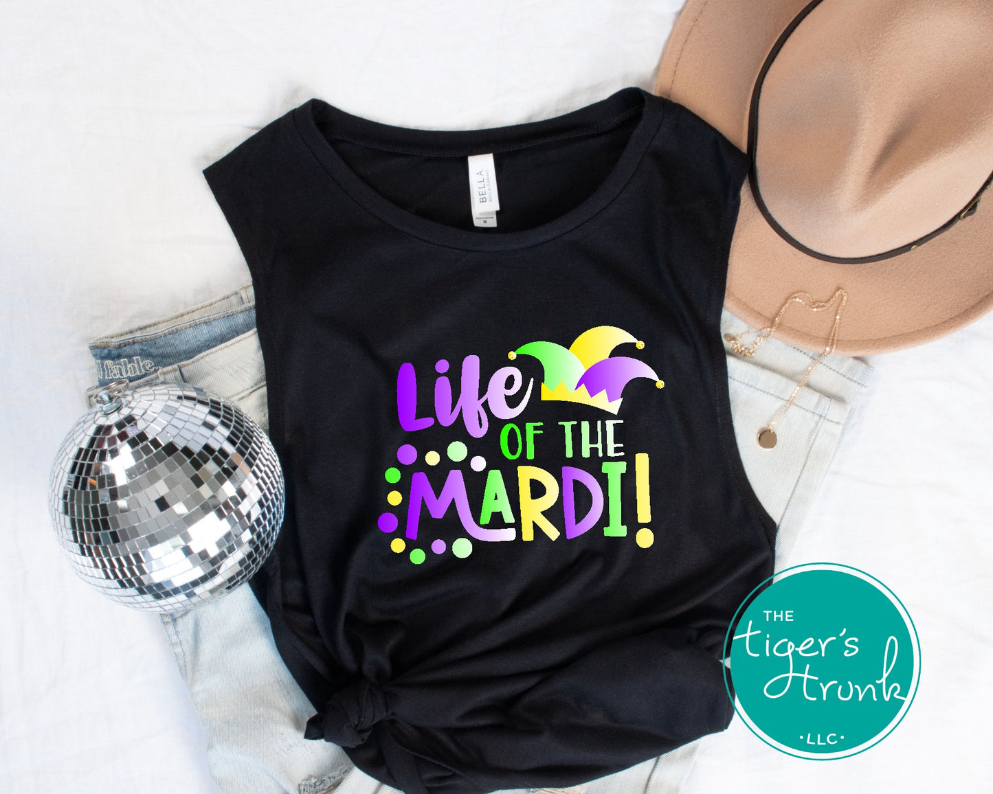 Life of the Mardi shirt with a watercolor design in purple, green, and gold, available as a t-shirt or muscle tank, perfect for Mardi Gras celebrations.