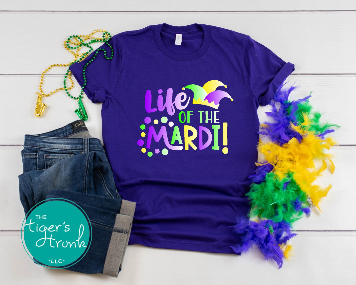 Life of the Mardi shirt with a watercolor design in purple, green, and gold, available as a t-shirt or muscle tank, perfect for Mardi Gras celebrations.