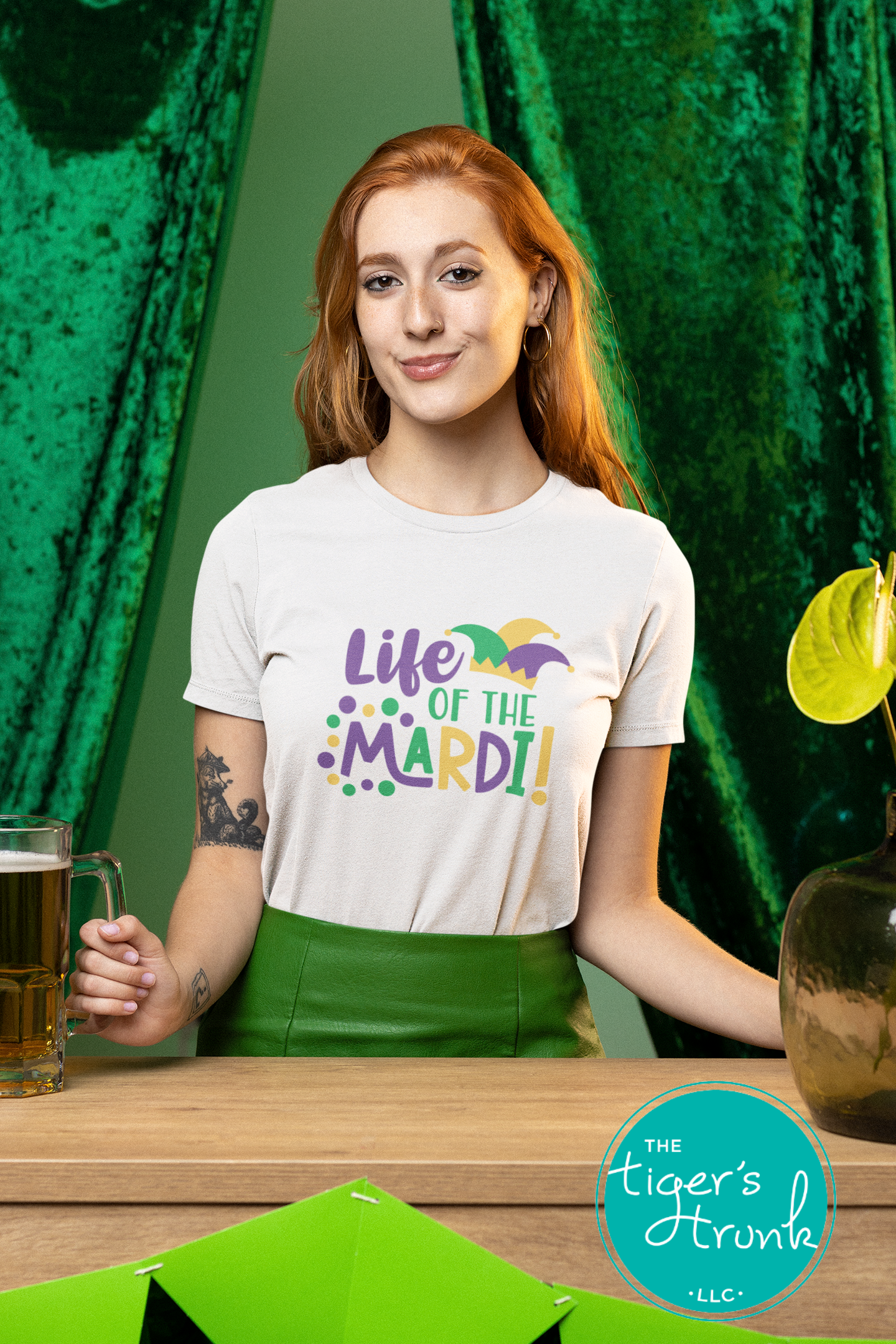 Life of the Mardi shirt with a watercolor design in purple, green, and gold, available as a t-shirt or muscle tank, perfect for Mardi Gras celebrations.