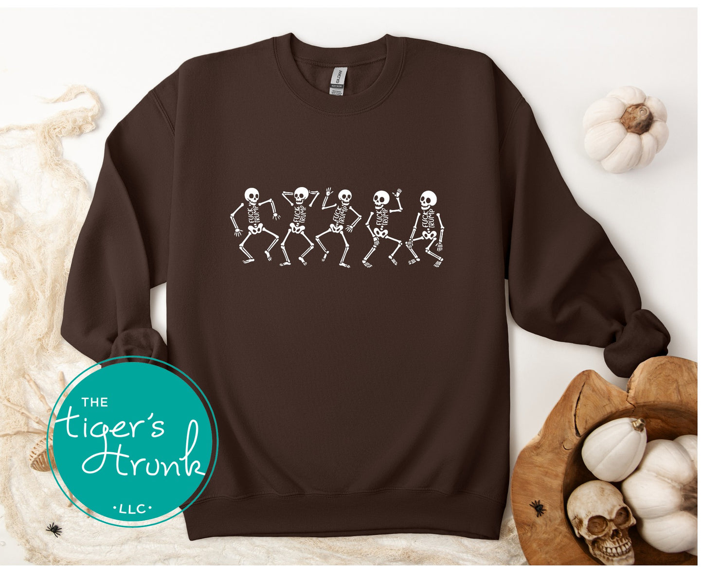 Brown sweatshirt with skeleton design on a white background, featuring 'The Tiger's Trunk' logo.