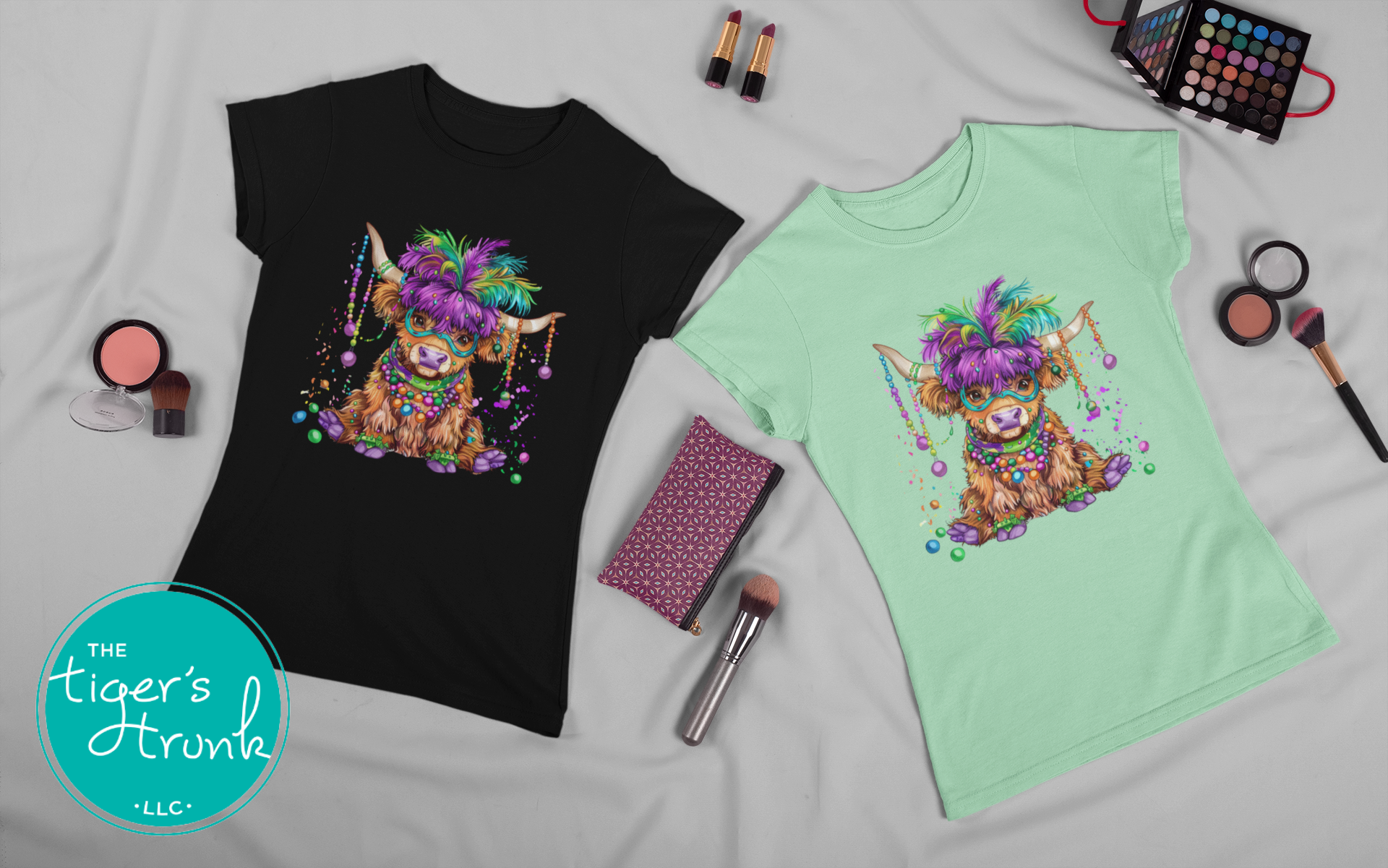 Mardi Gras t-shirt featuring a watercolor heifer adorned with colorful feathers and beads, perfect for festive celebrations.