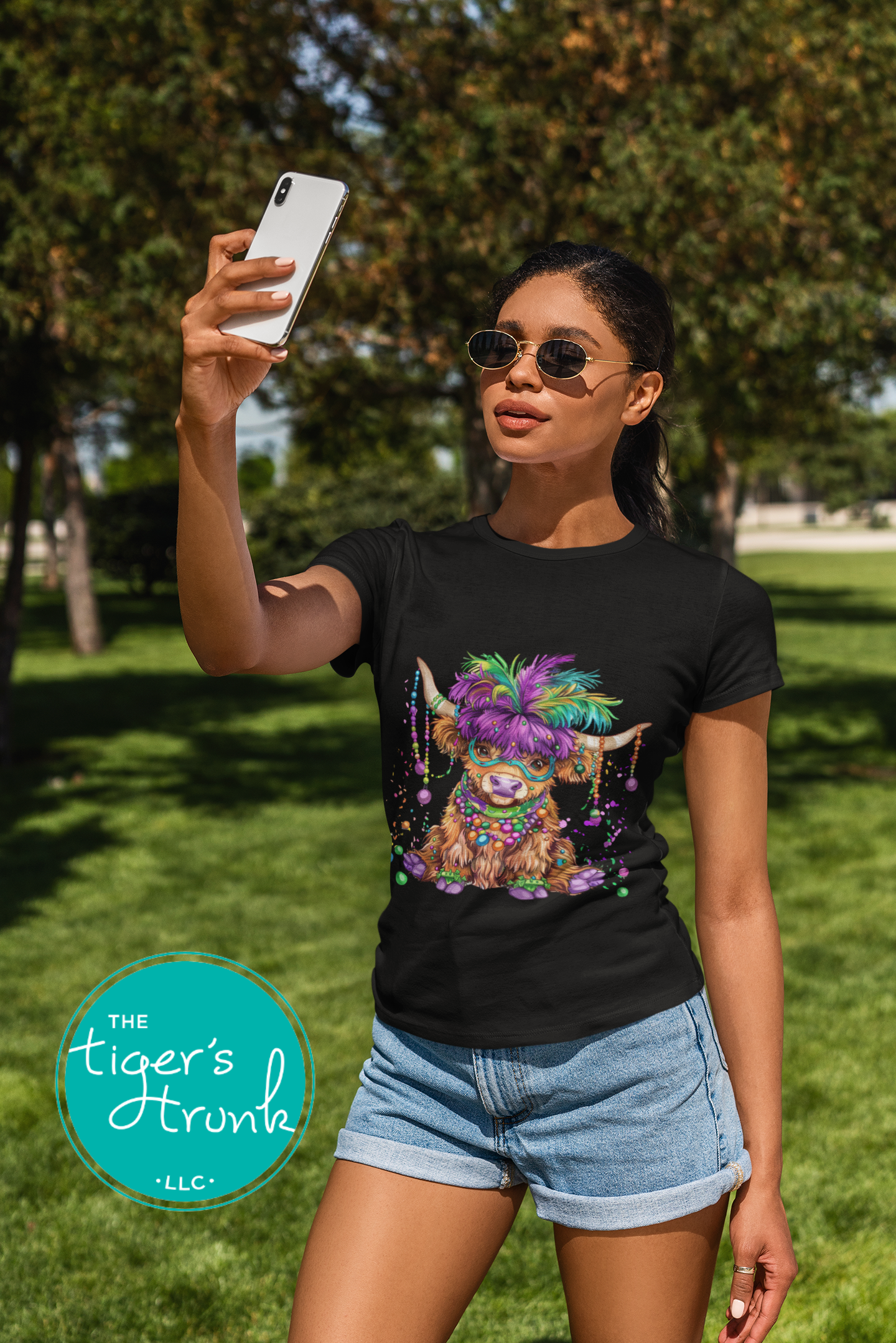 Mardi Gras t-shirt featuring a watercolor heifer adorned with colorful feathers and beads, perfect for festive celebrations.