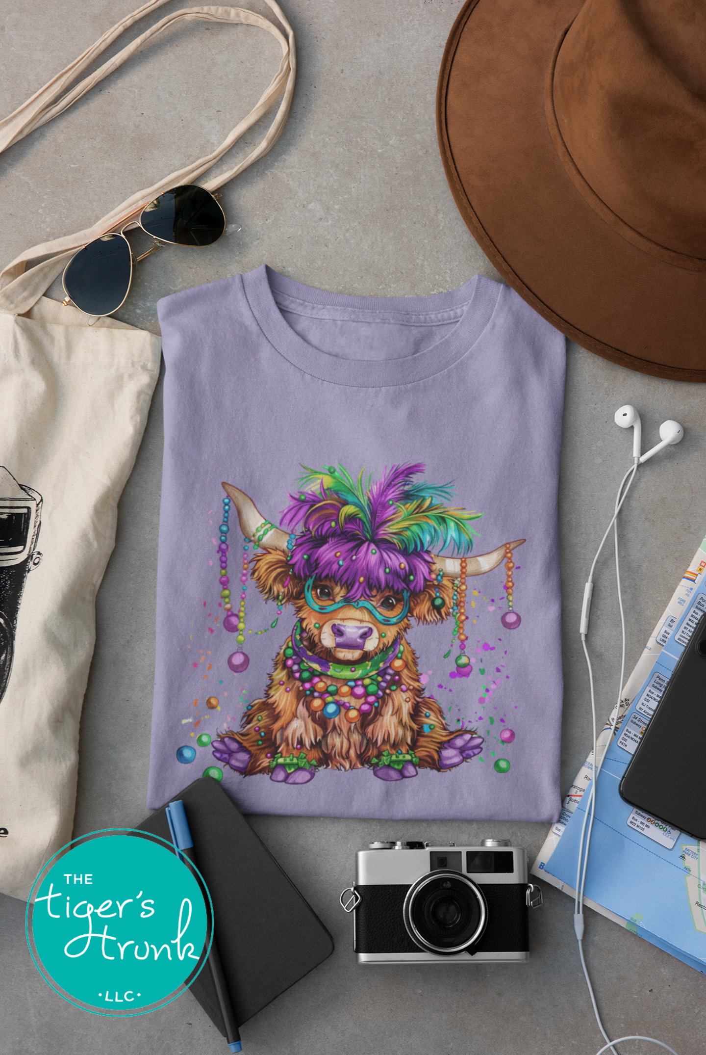 Mardi Gras t-shirt featuring a watercolor heifer adorned with colorful feathers and beads, perfect for festive celebrations.