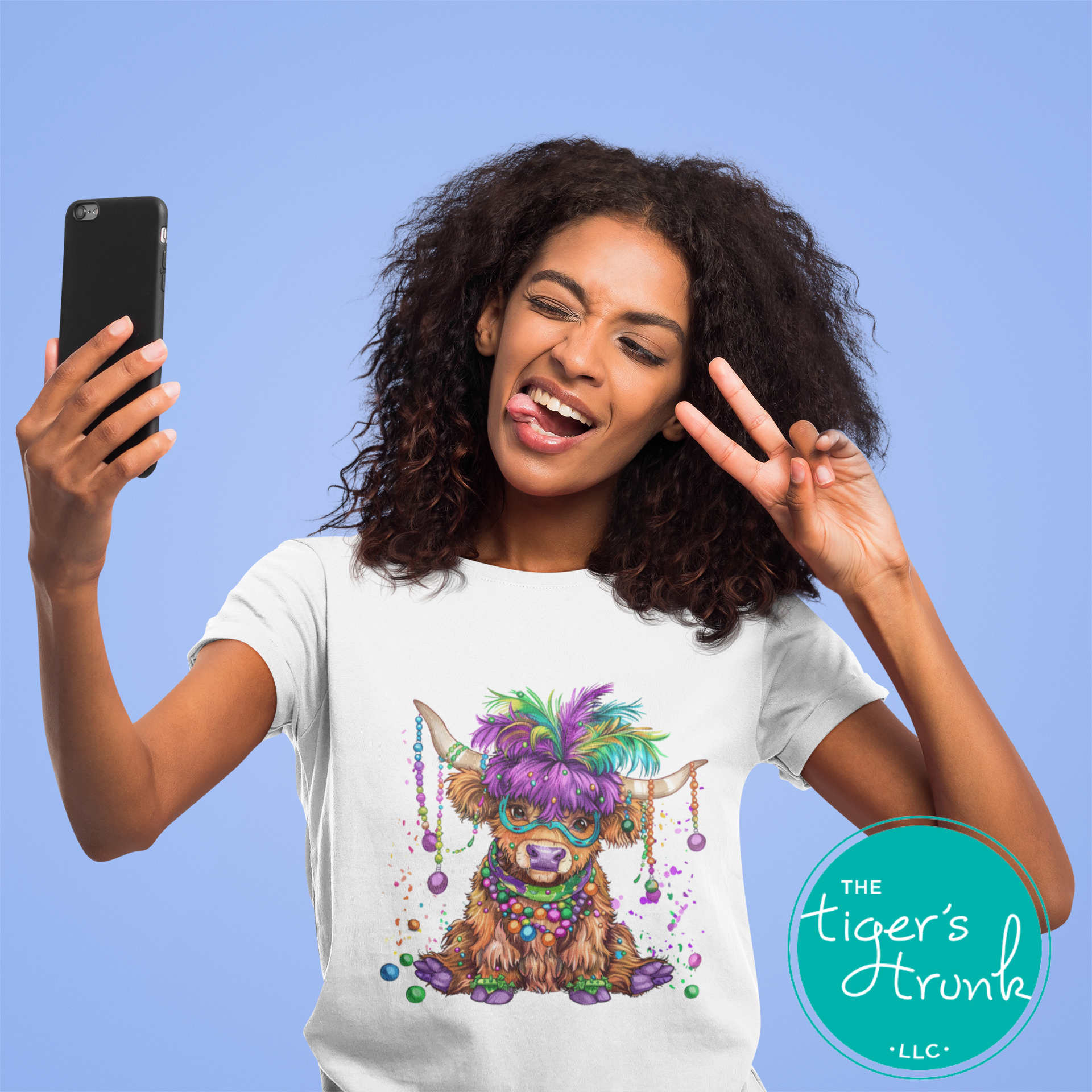 Mardi Gras t-shirt featuring a watercolor heifer adorned with colorful feathers and beads, perfect for festive celebrations.