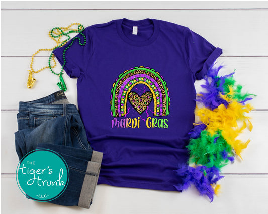 Mardi Gras t-shirt featuring the word "Mardi Gras" with a rainbow design in purple, green, and gold.