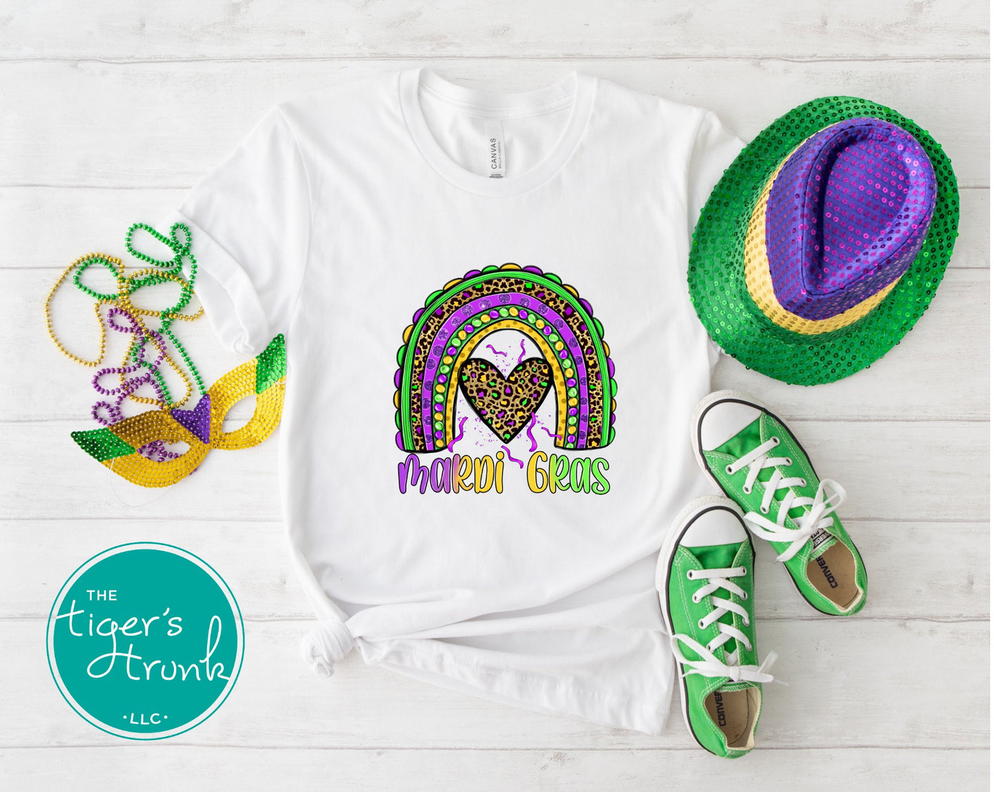 Mardi Gras t-shirt featuring the word "Mardi Gras" with a rainbow design in purple, green, and gold.