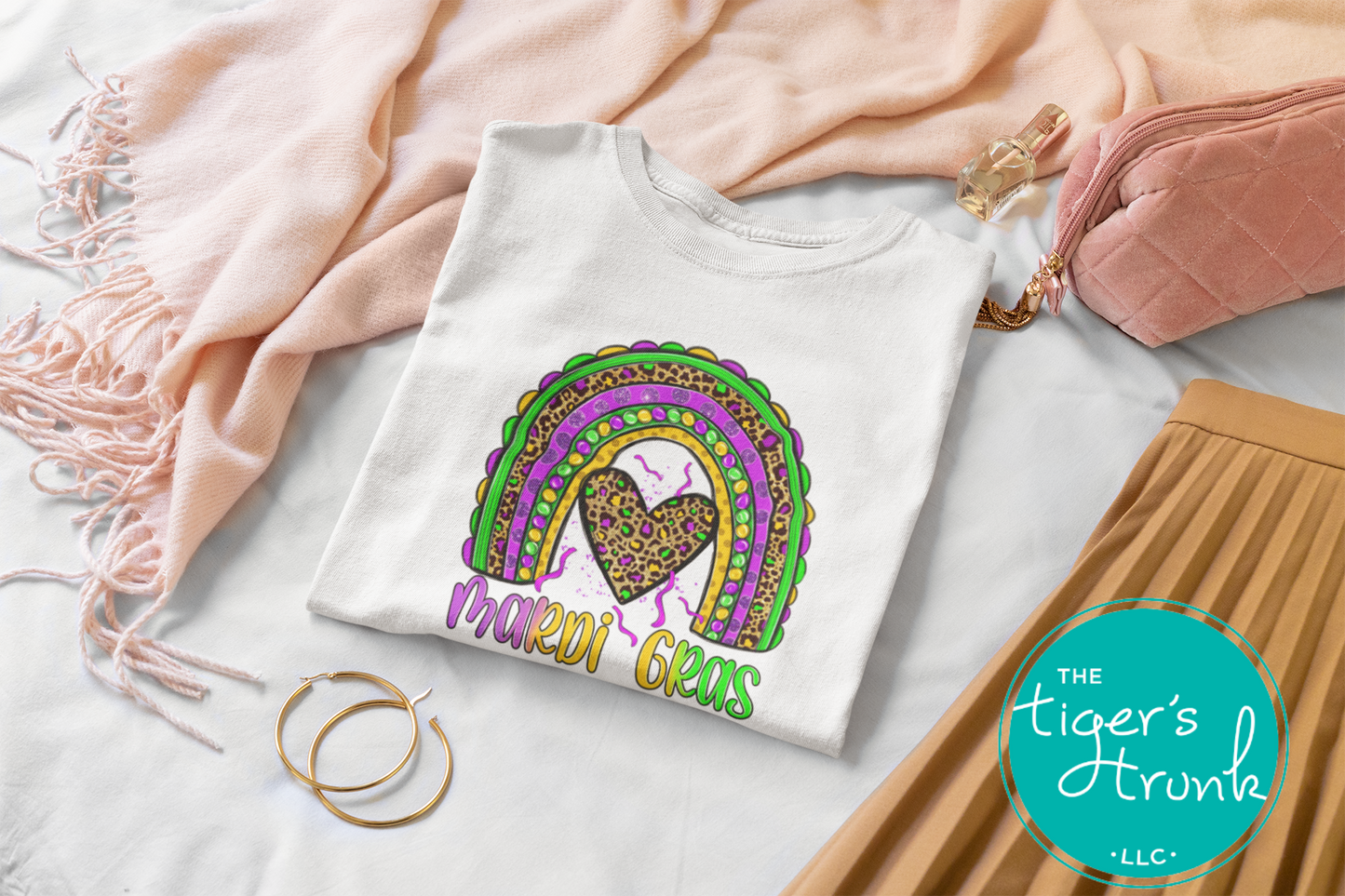 Mardi Gras t-shirt featuring the word "Mardi Gras" with a rainbow design in purple, green, and gold.