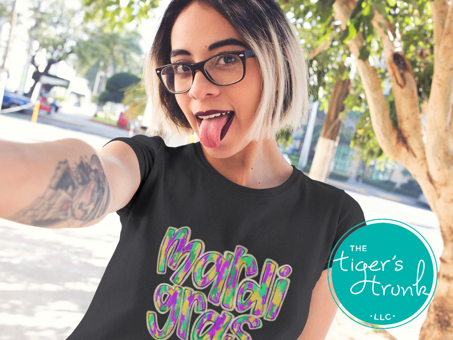 Mardi Gras t-shirt and muscle tank with hand-drawn paintbrush font in purple, green, and gold, perfect for festivals, parades, and celebrations.