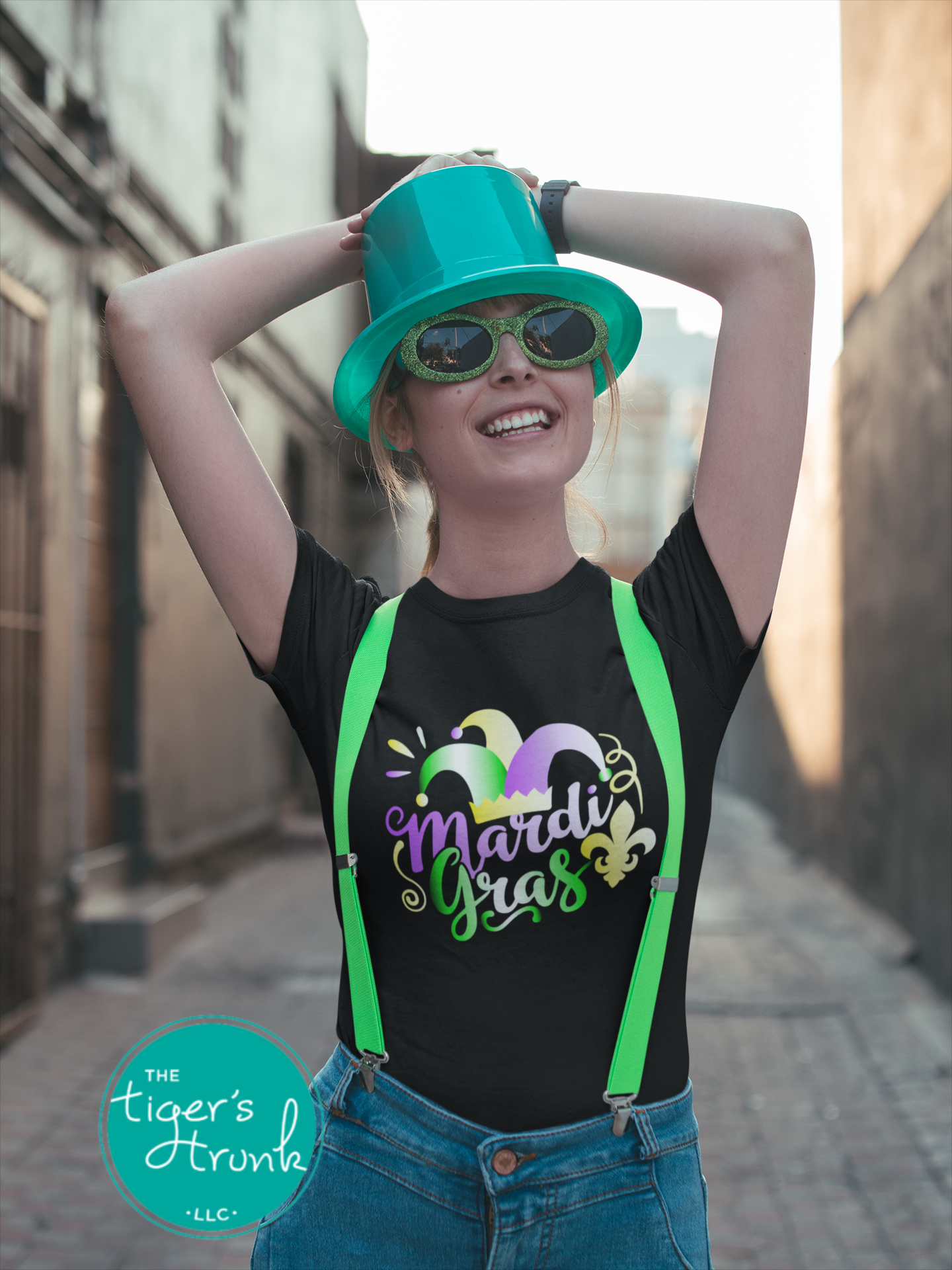 Mardi Gras t-shirt featuring vivid watercolor text in classic Mardi Gras colors of purple, green, and gold, perfect for celebrations.