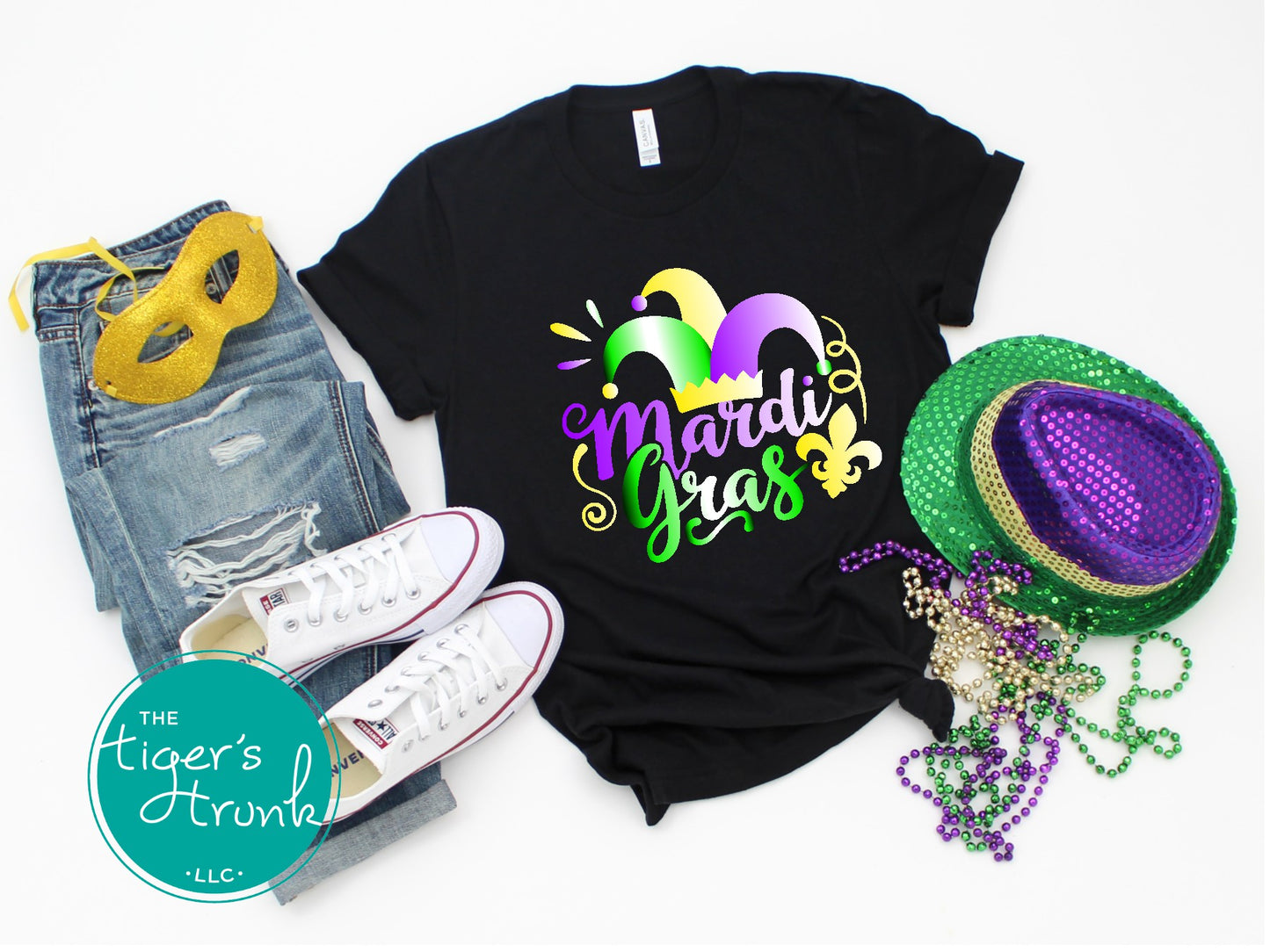 Mardi Gras t-shirt featuring vivid watercolor text in classic Mardi Gras colors of purple, green, and gold, perfect for celebrations.