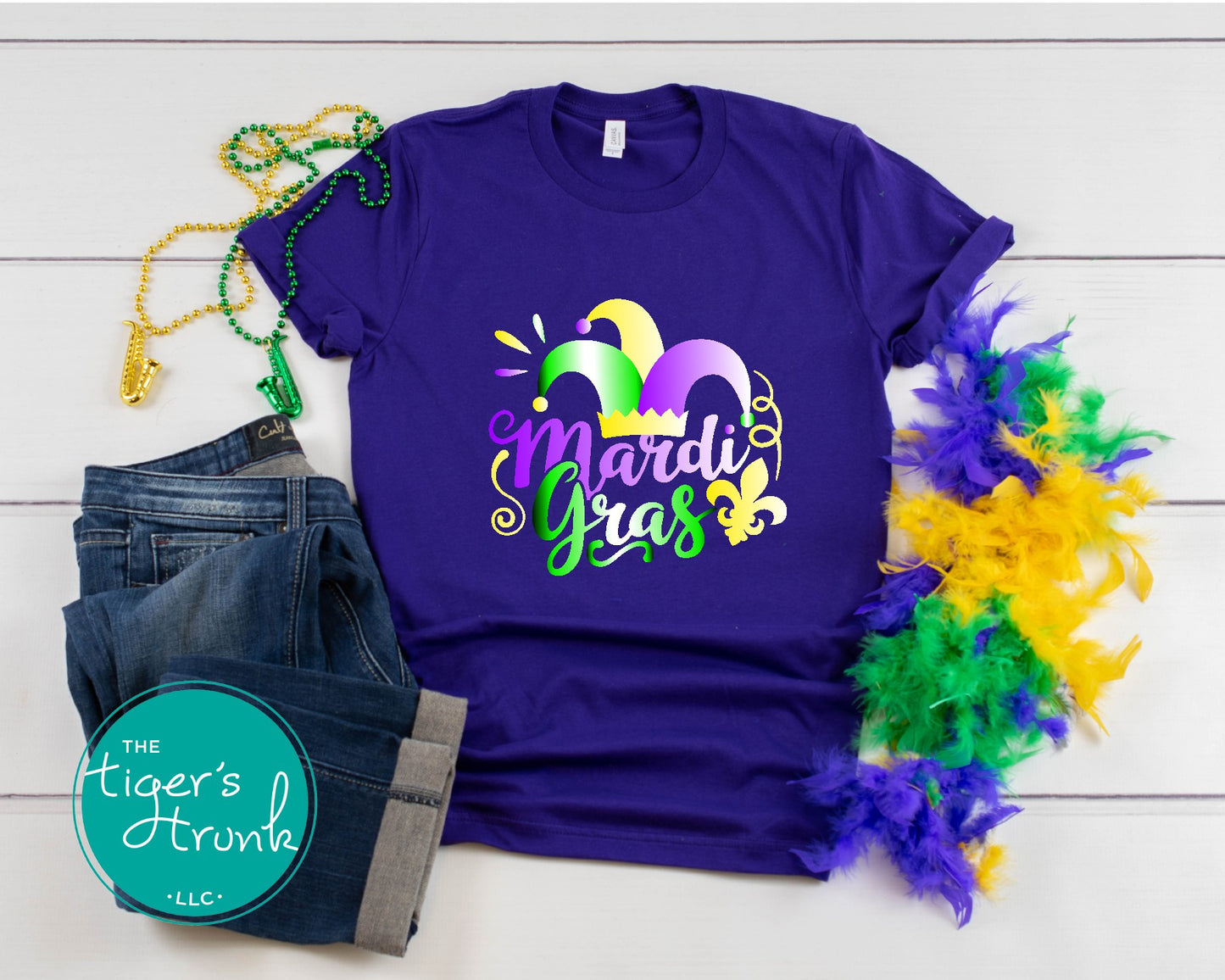 Mardi Gras t-shirt featuring vivid watercolor text in classic Mardi Gras colors of purple, green, and gold, perfect for celebrations.