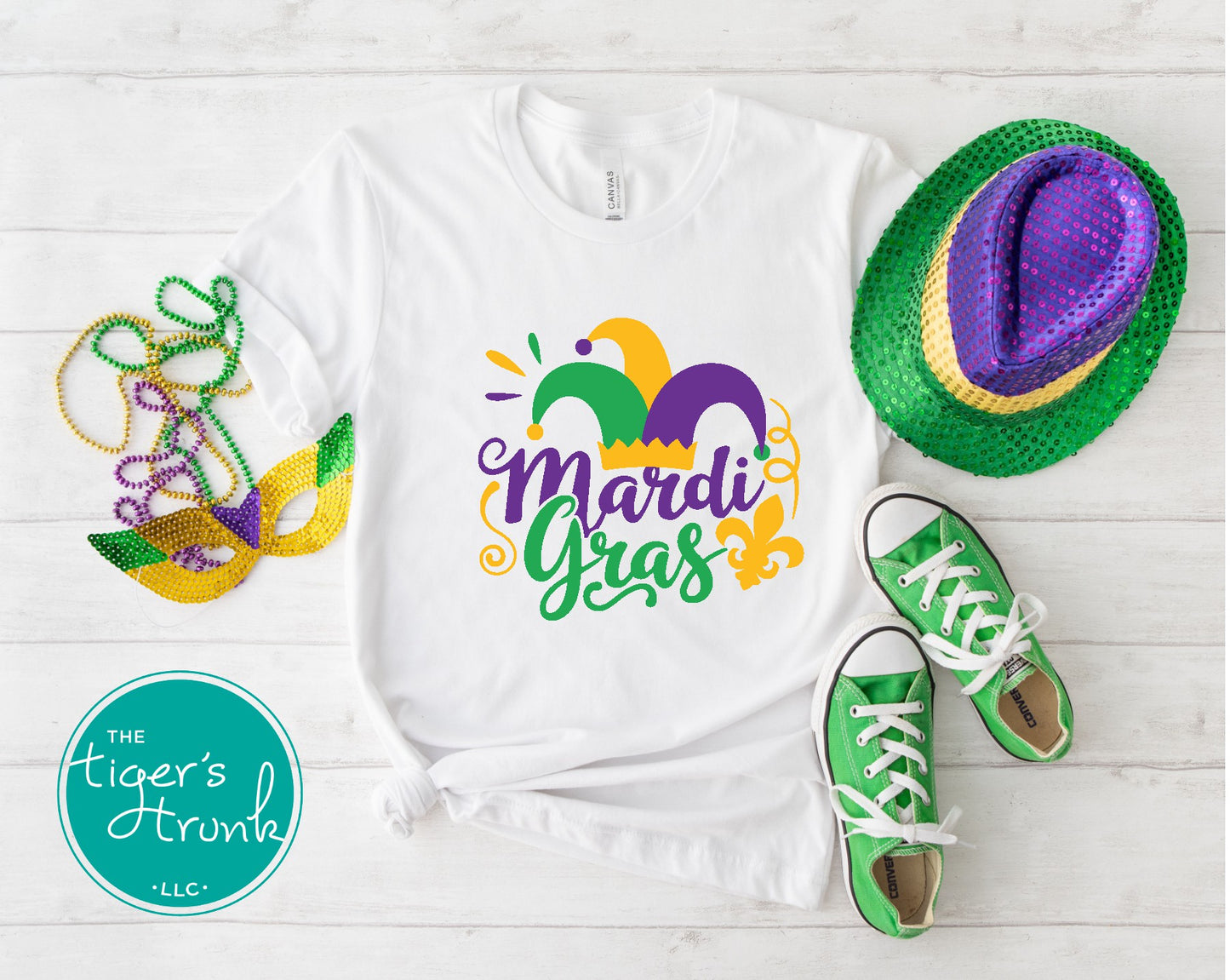 Mardi Gras t-shirt featuring vivid watercolor text in classic Mardi Gras colors of purple, green, and gold, perfect for celebrations.