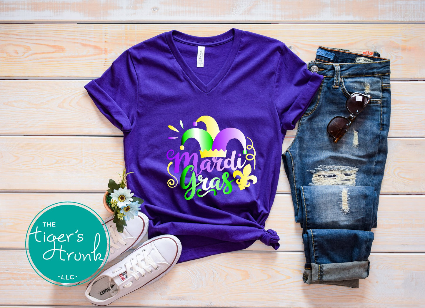 Festive Mardi Gras shirts with watercolor text in purple, green, and gold. Available as V-neck and muscle tank styles for parades or parties.