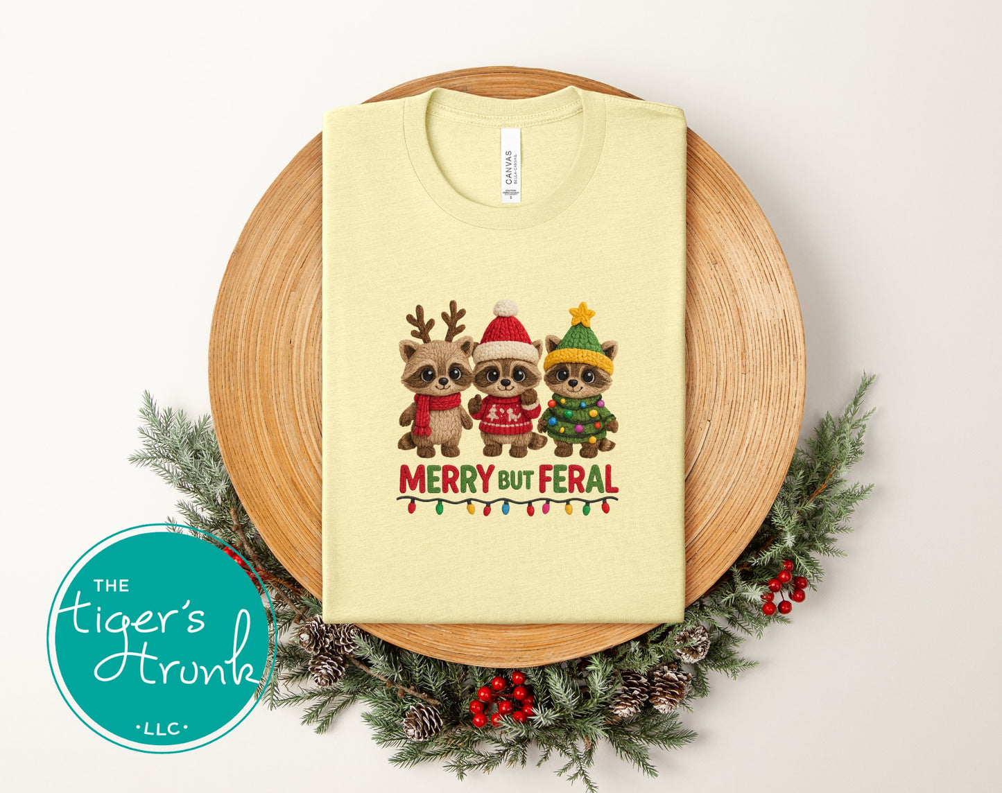 Beige t-shirt with Christmas-themed design on a wooden plate with decorative elements.