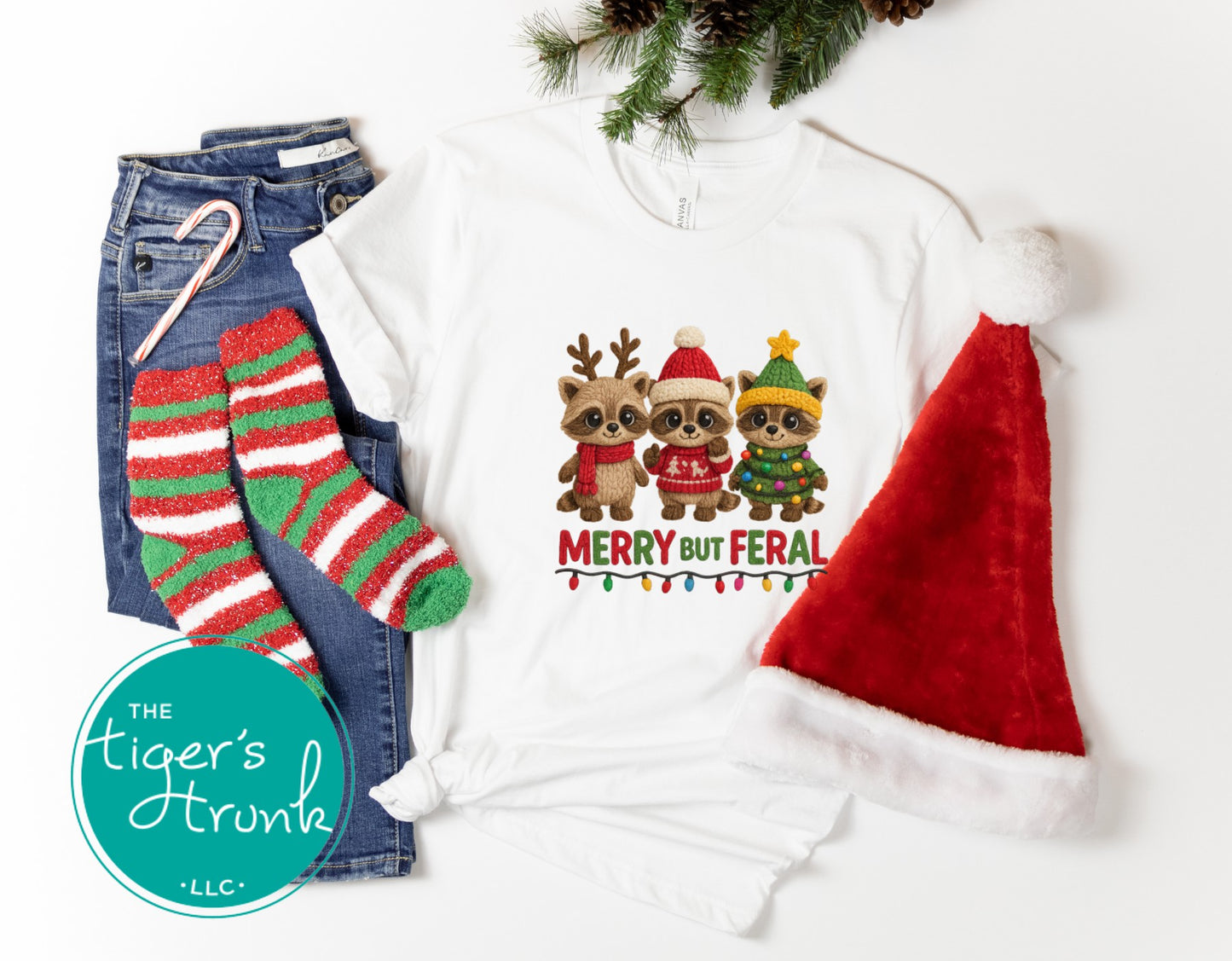 White sweatshirt with Christmas-themed design, jeans, striped socks, and Santa hat on a white background.