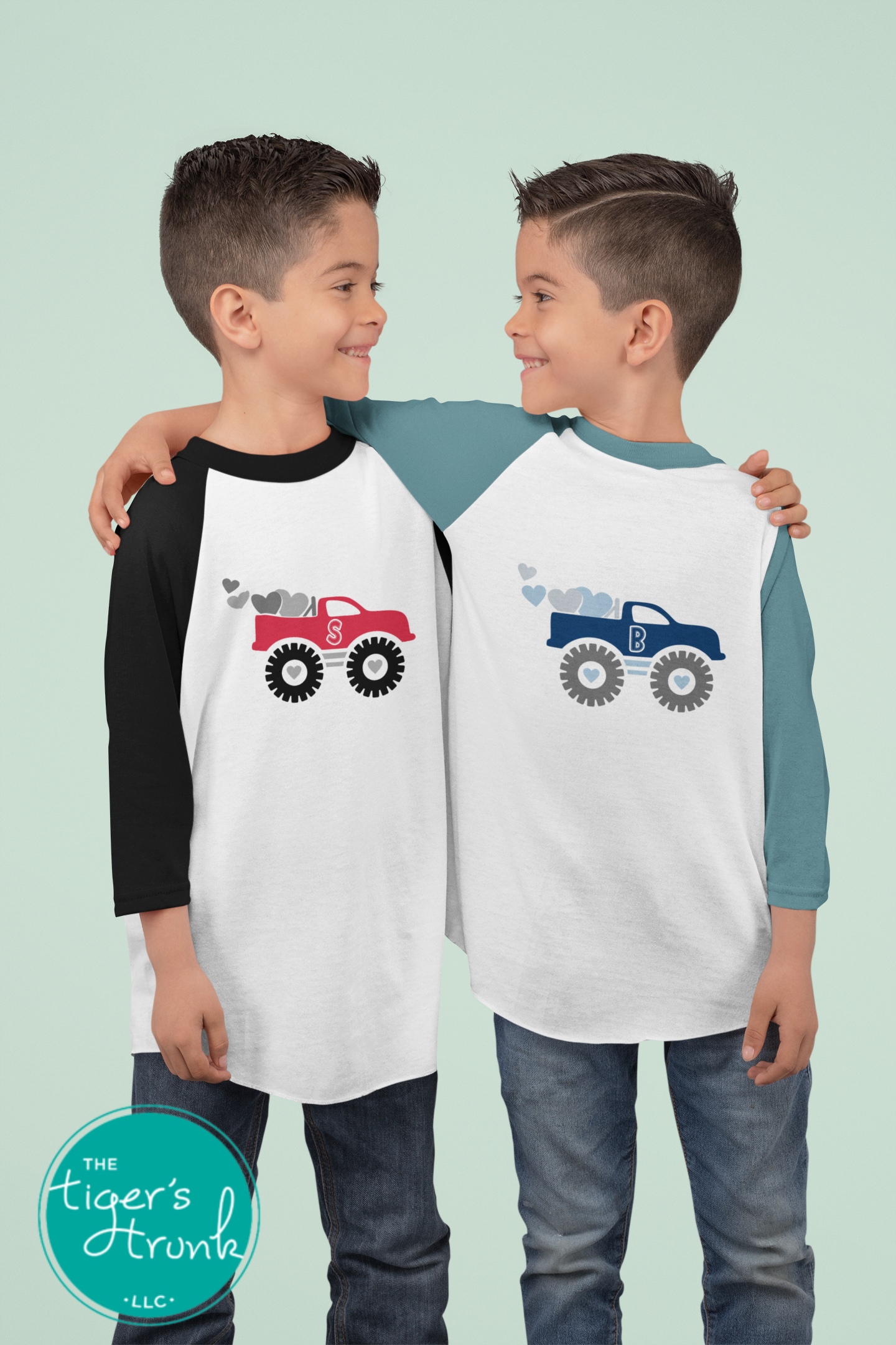 Valentine’s Day raglan shirt for kids with a monster truck and hearts design, personalized with a patchwork initial, available in three colors.