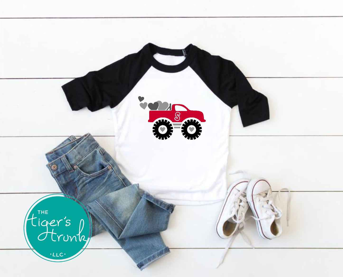 Valentine’s Day raglan shirt for kids with a monster truck and hearts design, personalized with a patchwork initial, available in three colors.