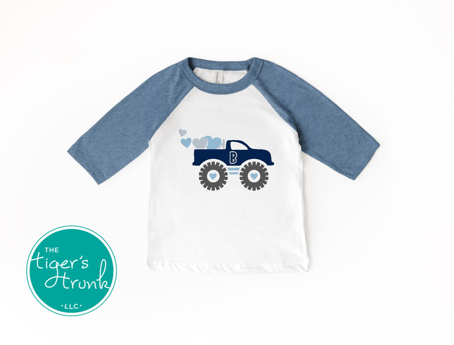 Valentine’s Day raglan shirt for kids with a monster truck and hearts design, personalized with a patchwork initial, available in three colors.