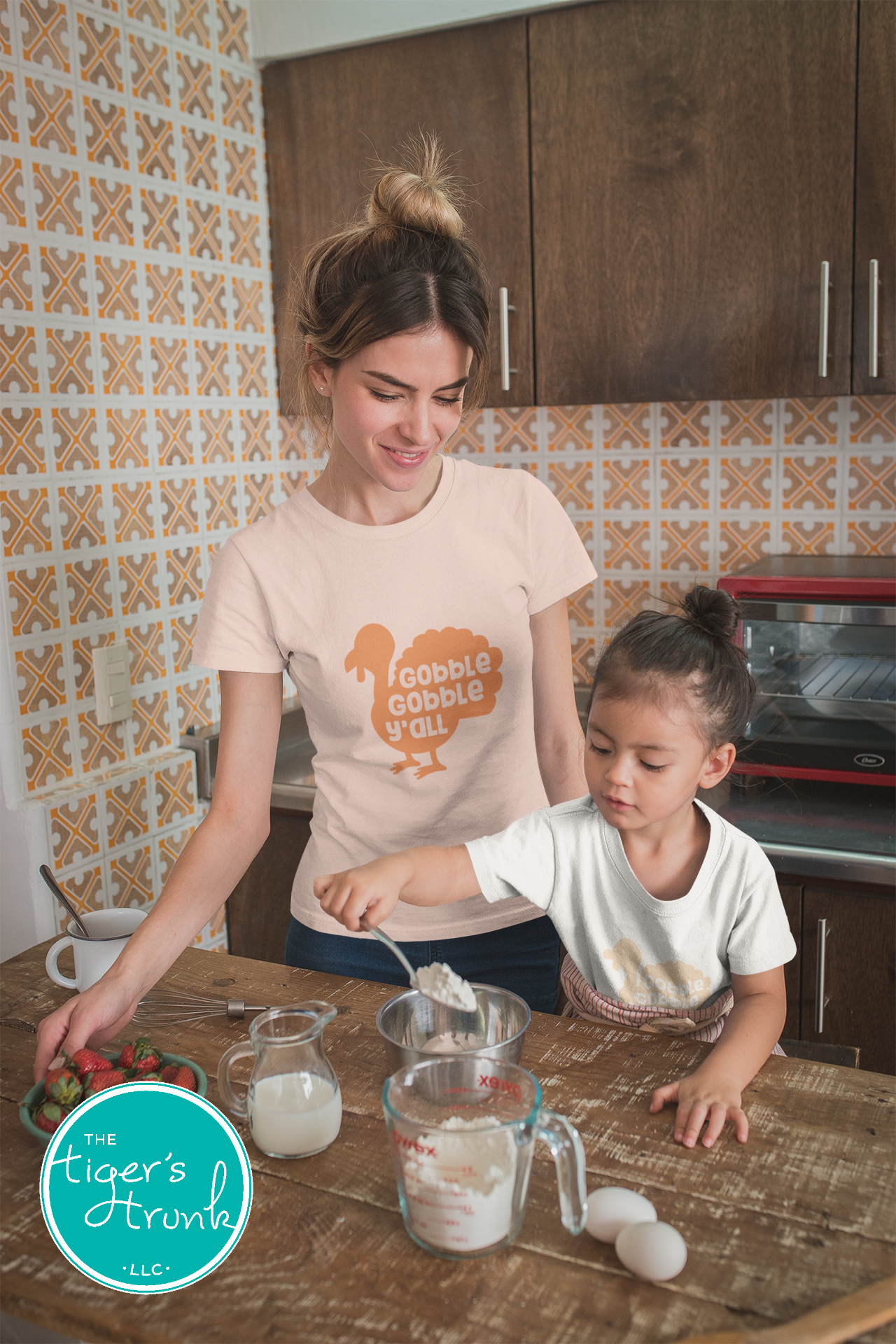 Woman and child in a kitchen preparing food together.