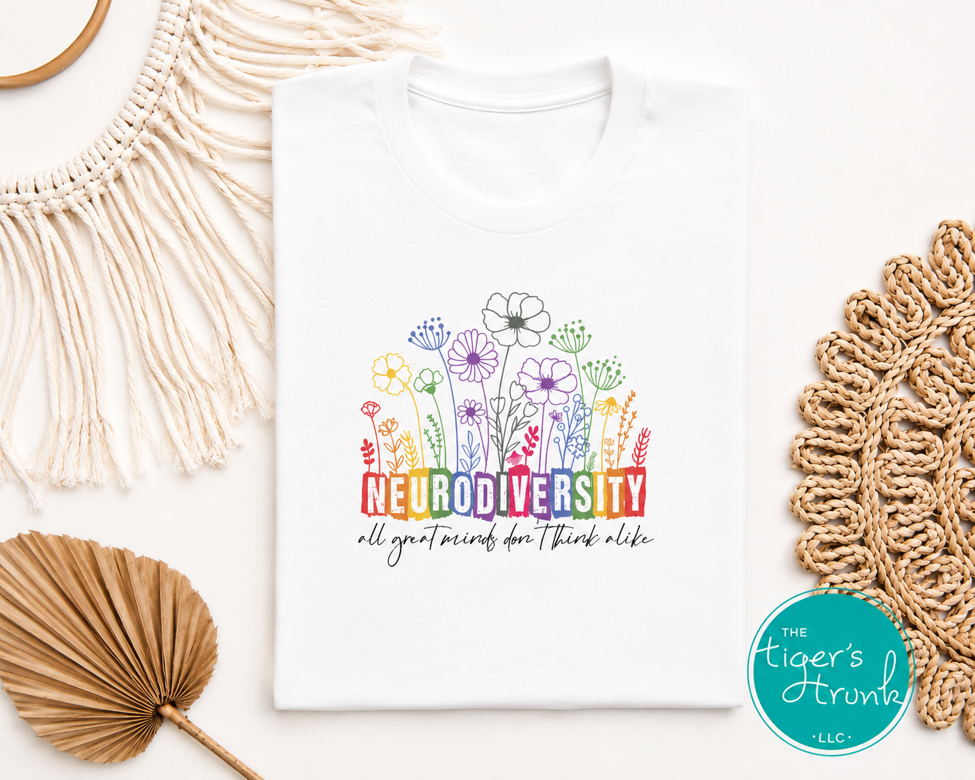 White neurodiversity shirt with rainbow floral design and inclusive awareness message