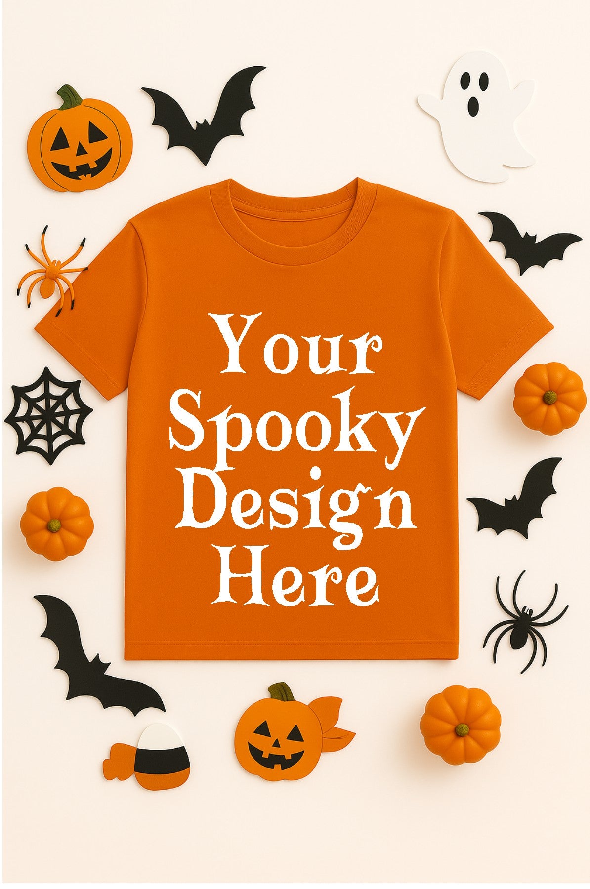 Orange t-shirt with 'Your Spooky Design Here' text, surrounded by Halloween decorations on a white background.