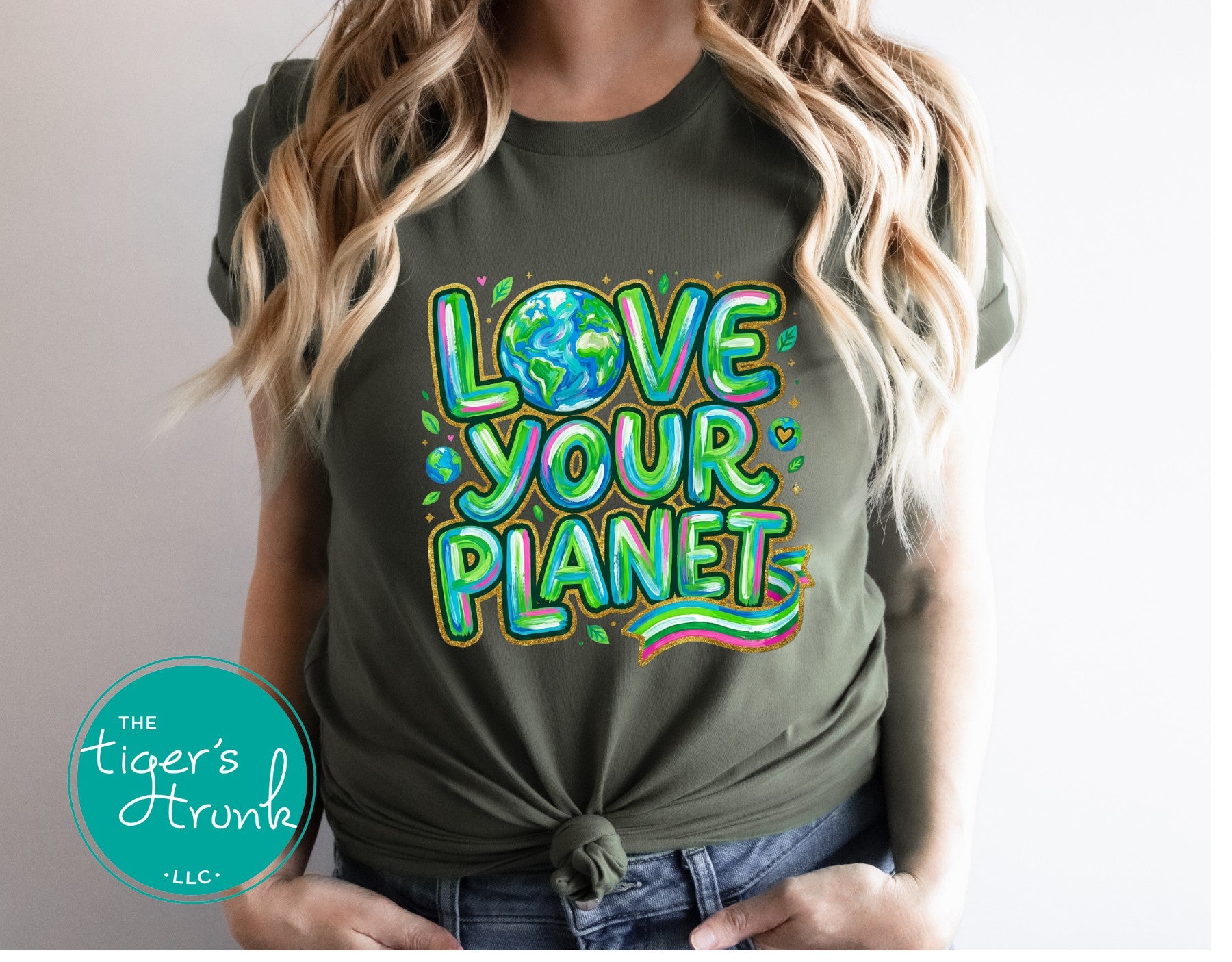 Person wearing a green t-shirt with 'Love Your Planet' text and Earth graphic, brand 'The Tiger's Den' visible.