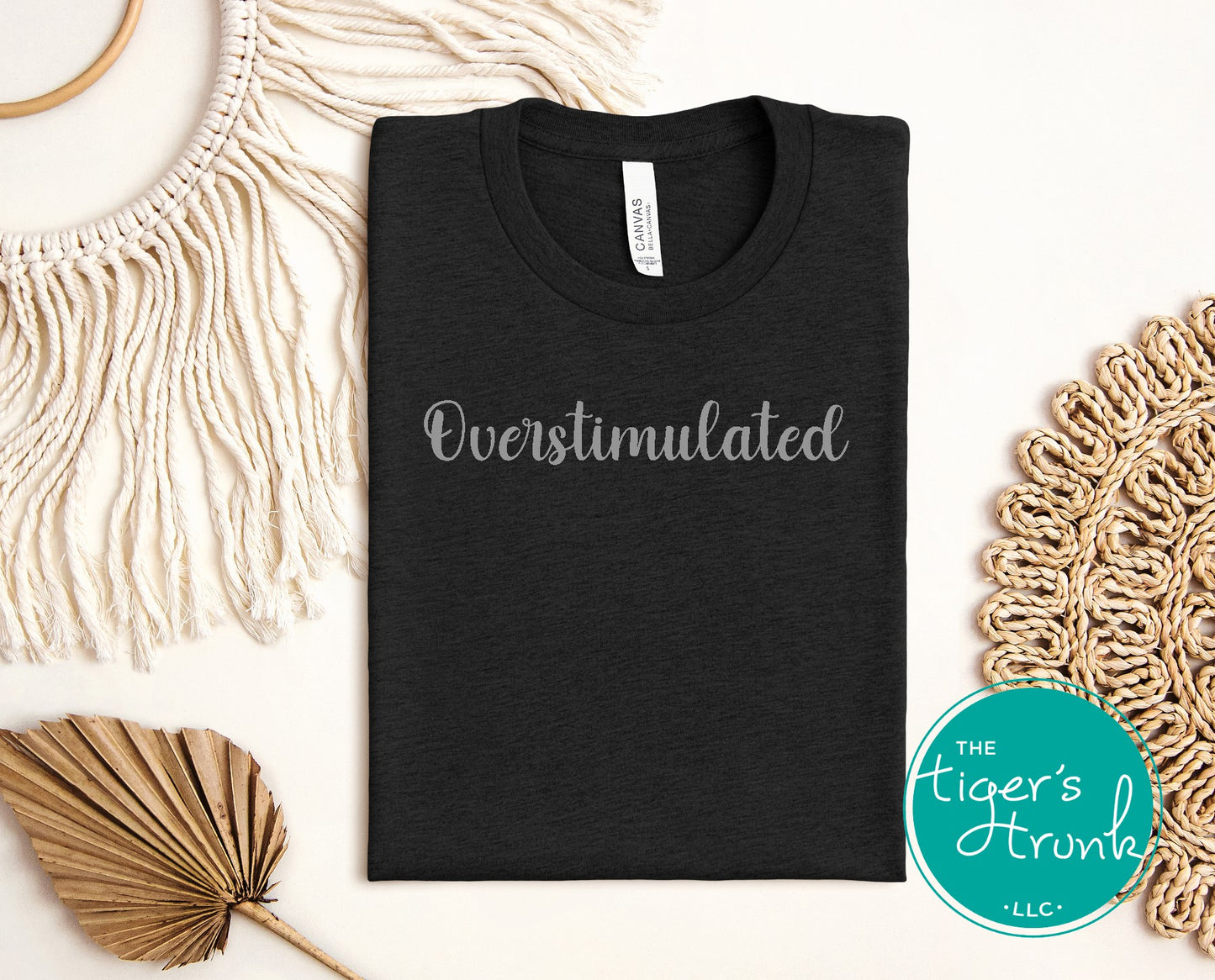 Black t-shirt with overstimulated text in soft script