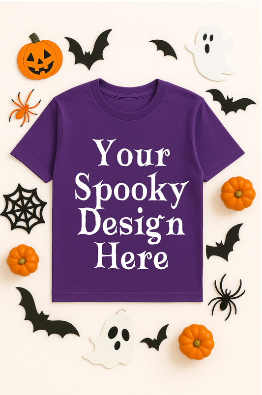 Purple t-shirt with 'Your Spooky Design Here' text, surrounded by Halloween decorations on a white background.