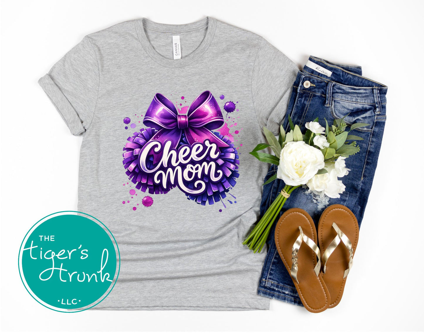 Gray t-shirt with 'Cheer Mom' design, jeans, sandals, and flowers on a white background.