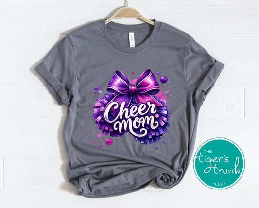 Gray t-shirt with a purple bow and 'Cheer Mom' text on a white background, featuring The Tiger's Trunk logo.
