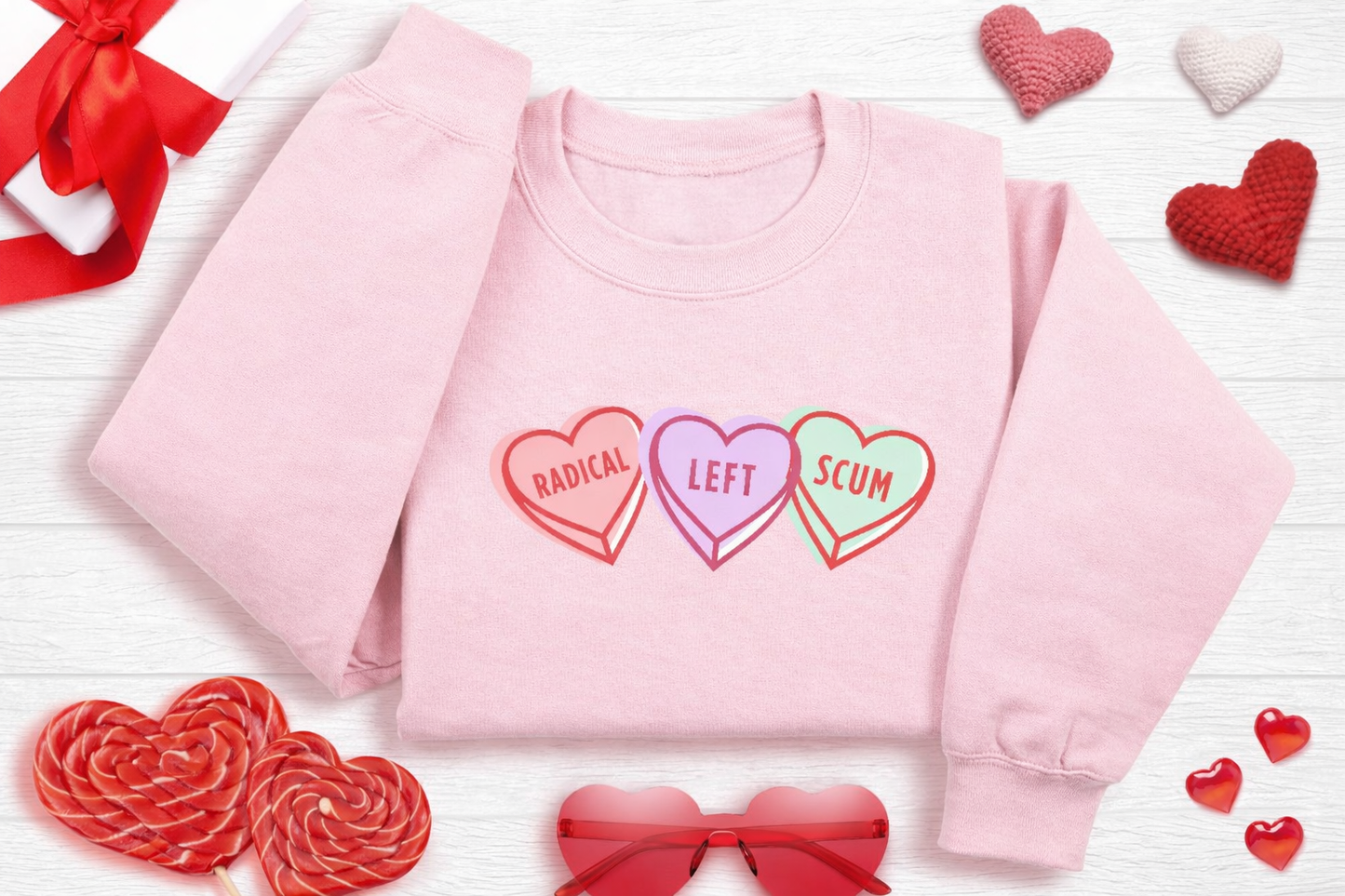 Pink sweatshirt with colorful heart designs and text on a white background with decorative hearts and ribbons.