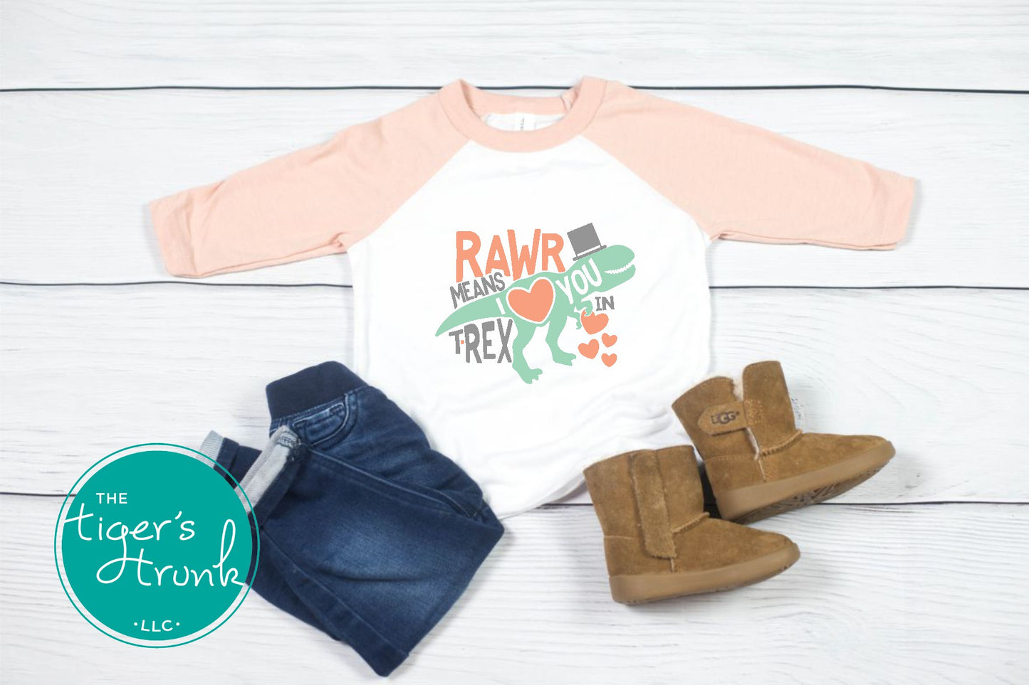 Kids Valentine’s Day t-shirt with a playful T-Rex graphic and the phrase Rawr Means I Love You in T-Rex, perfect for dinosaur fans.