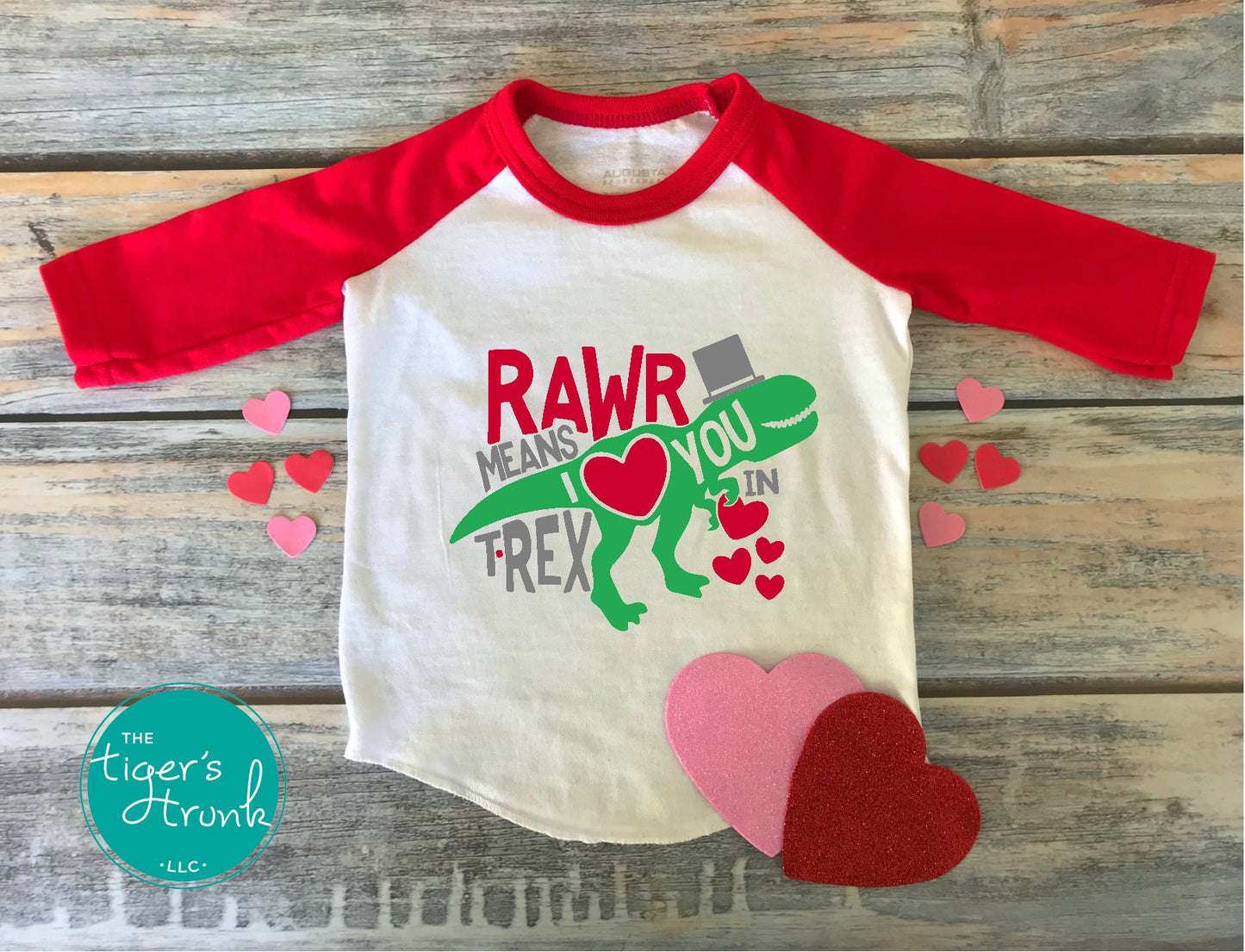 Kids Valentine’s Day t-shirt with a playful T-Rex graphic and the phrase Rawr Means I Love You in T-Rex, perfect for dinosaur fans.