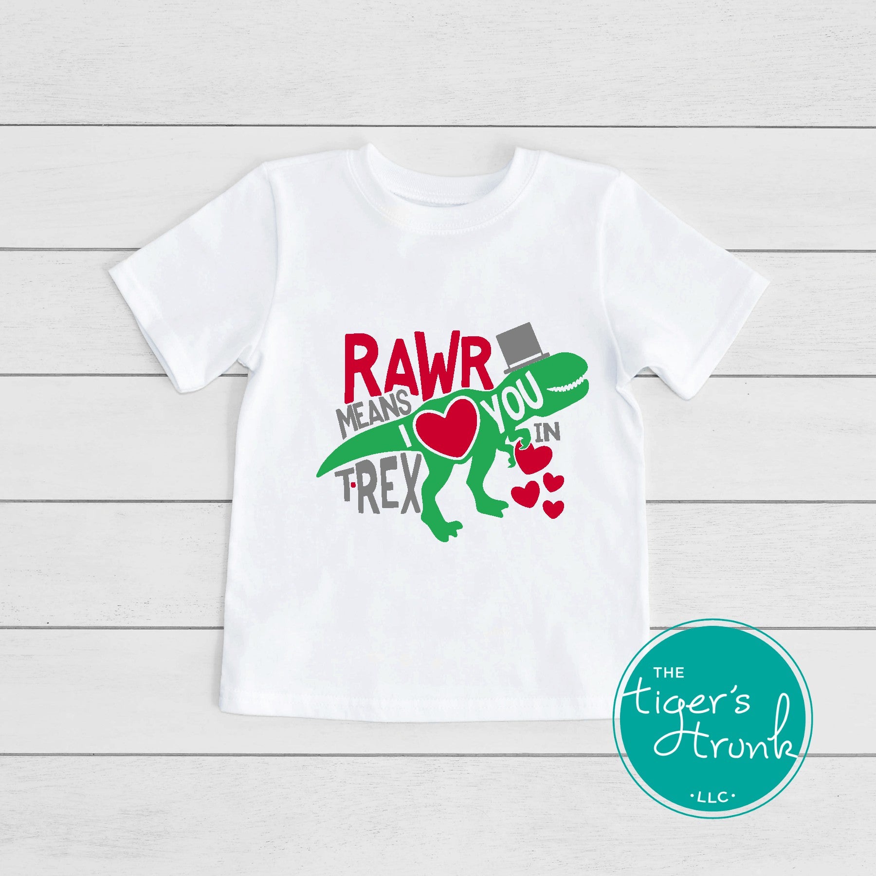 Kids Valentine’s Day t-shirt with a playful T-Rex graphic and the phrase Rawr Means I Love You in T-Rex, perfect for dinosaur fans.